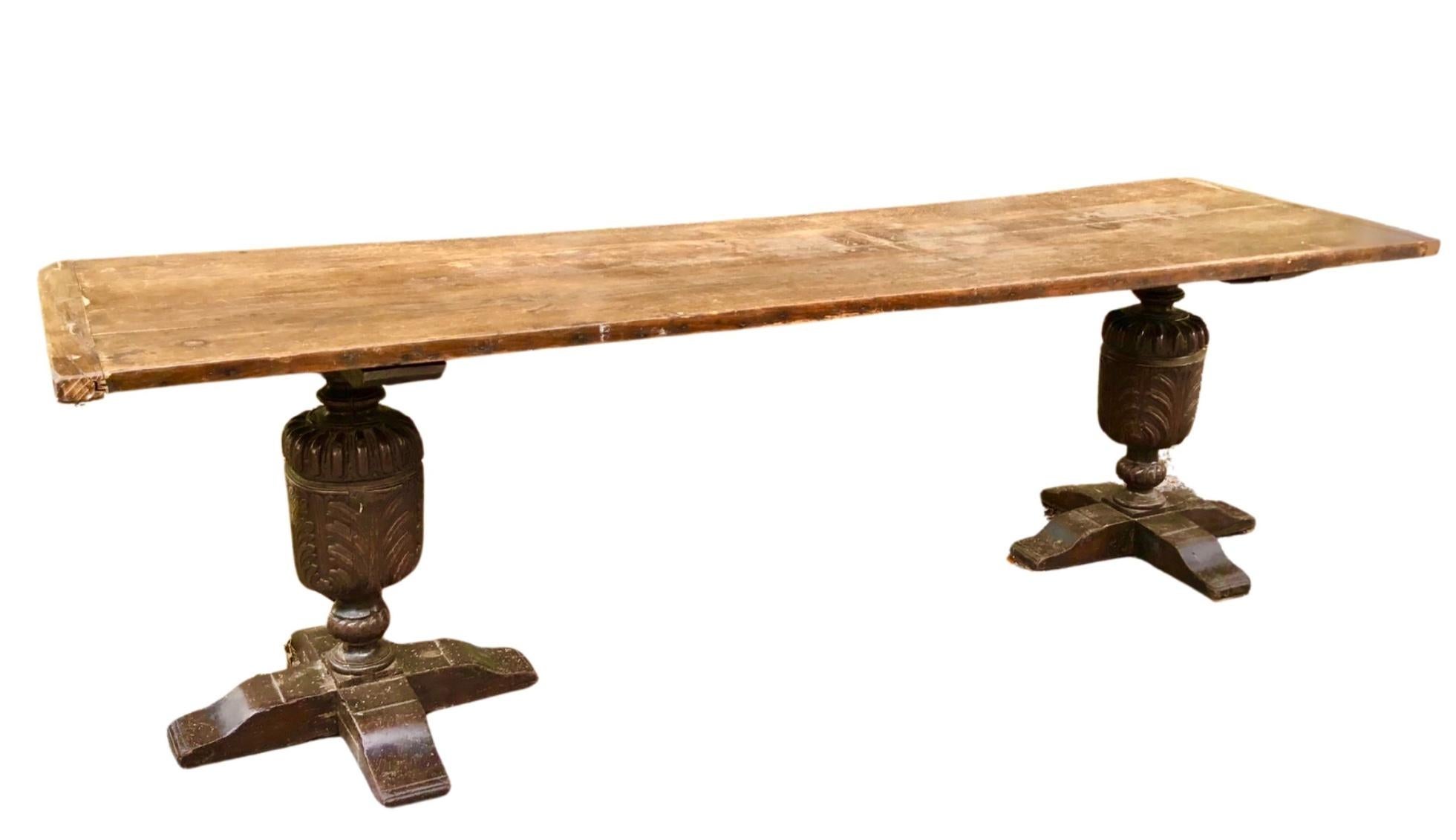 Large and fabulous 18th-century oak refectory table, the two board plank top supported on very large turned and carved bulbous supports. Wonderful old patina. Very stable. The top has a slight warp which just adds to the character and charm of this
