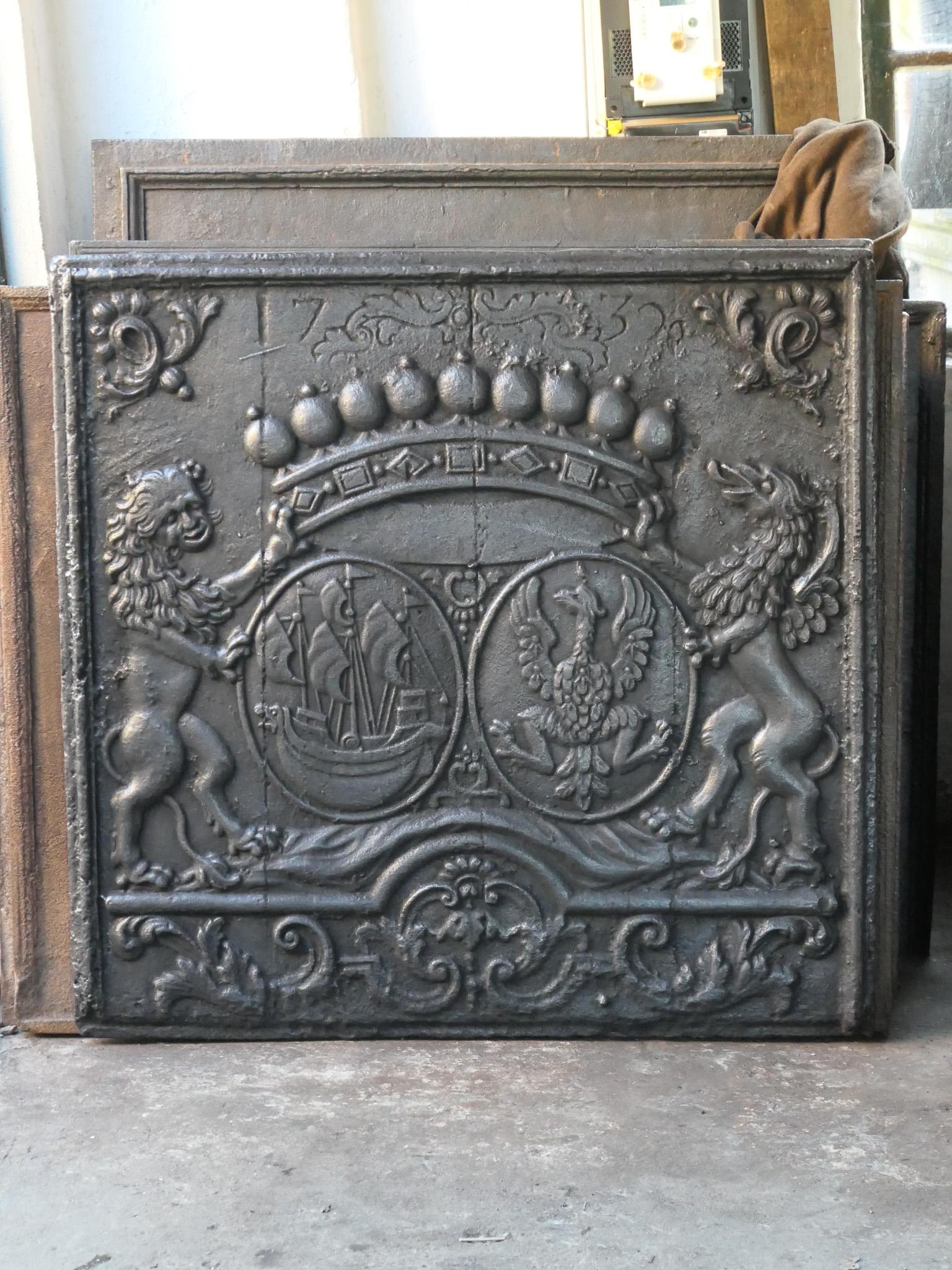 Beautiful 18th century French Louis XIV period fireback with a coat of arms. The date of production, 1732, is also cast in the fireback.

The fireback is made of cast iron and has a black patina. It is in a good condition, no cracks.

This large