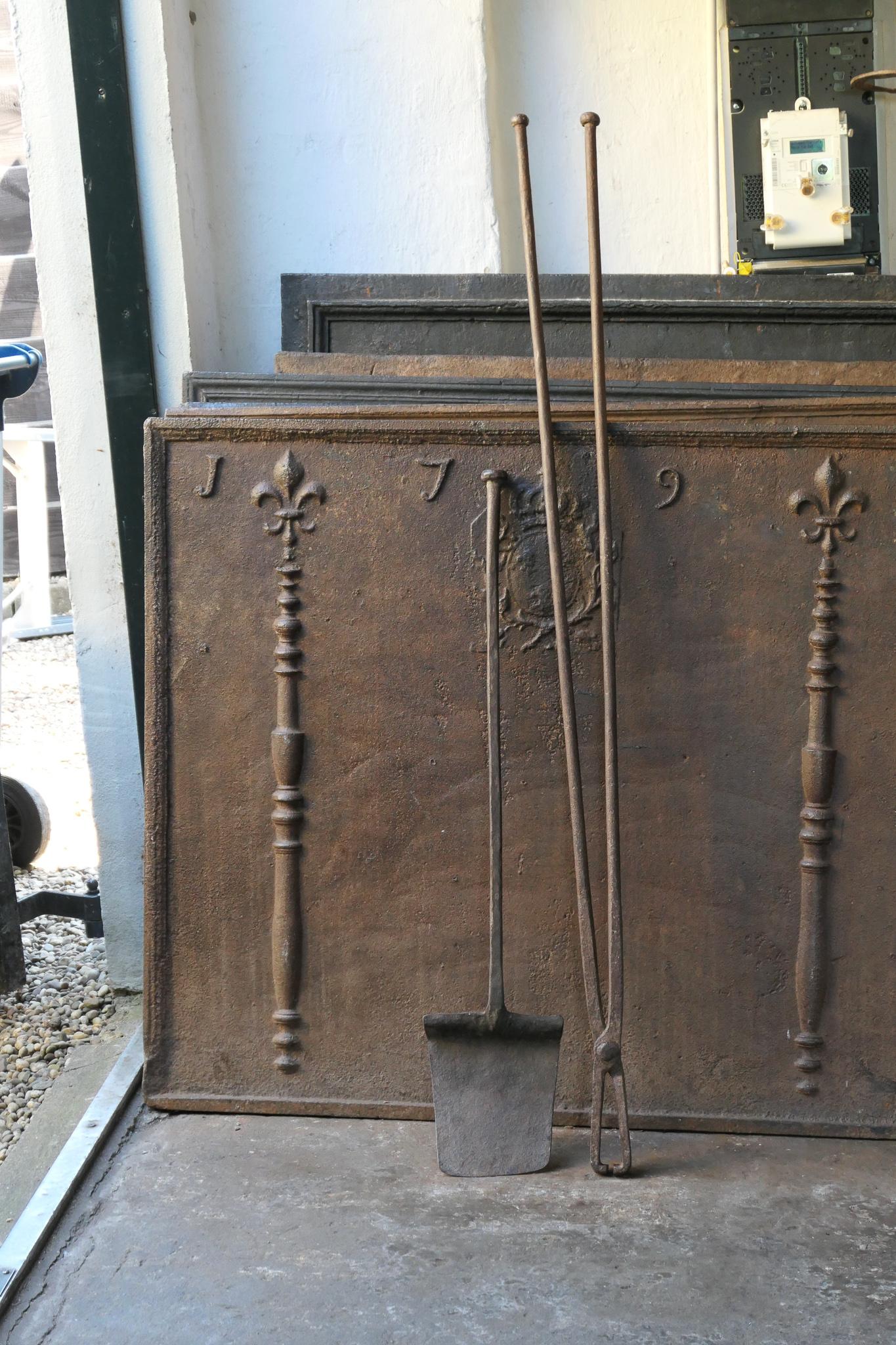Large 18th century French Louis XV fireplace toolset. The toolset is made of wrought iron. It is in a good condition and it is fully functional.








