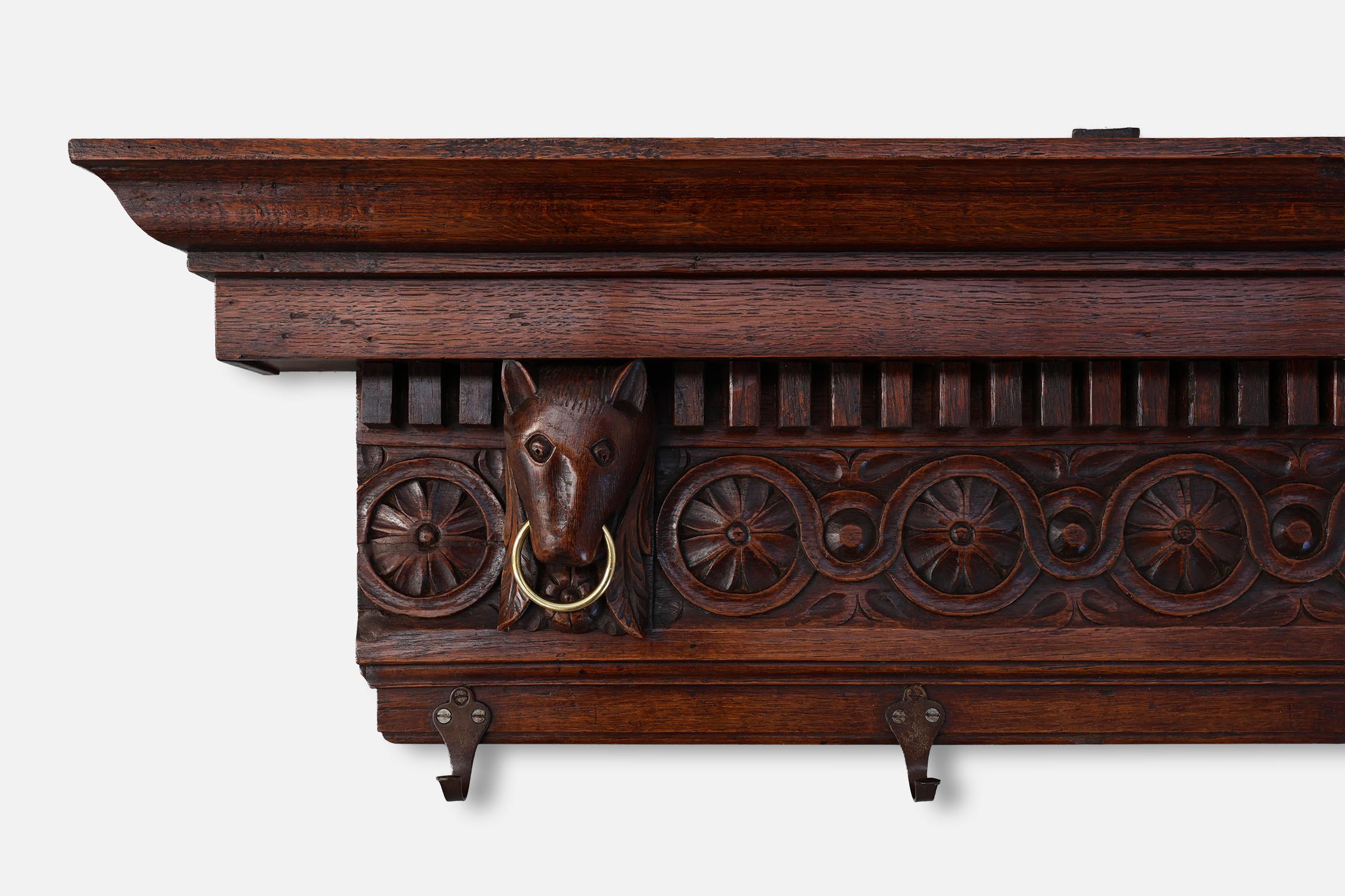 France / 18th century / coat rack / oak, copper / Baroque / Gothic revival / antique

Antique coat rack in hand carved oak from the 18th century. This impressive rack features four animal heads, each with a round copper ring and eight hooks. In the