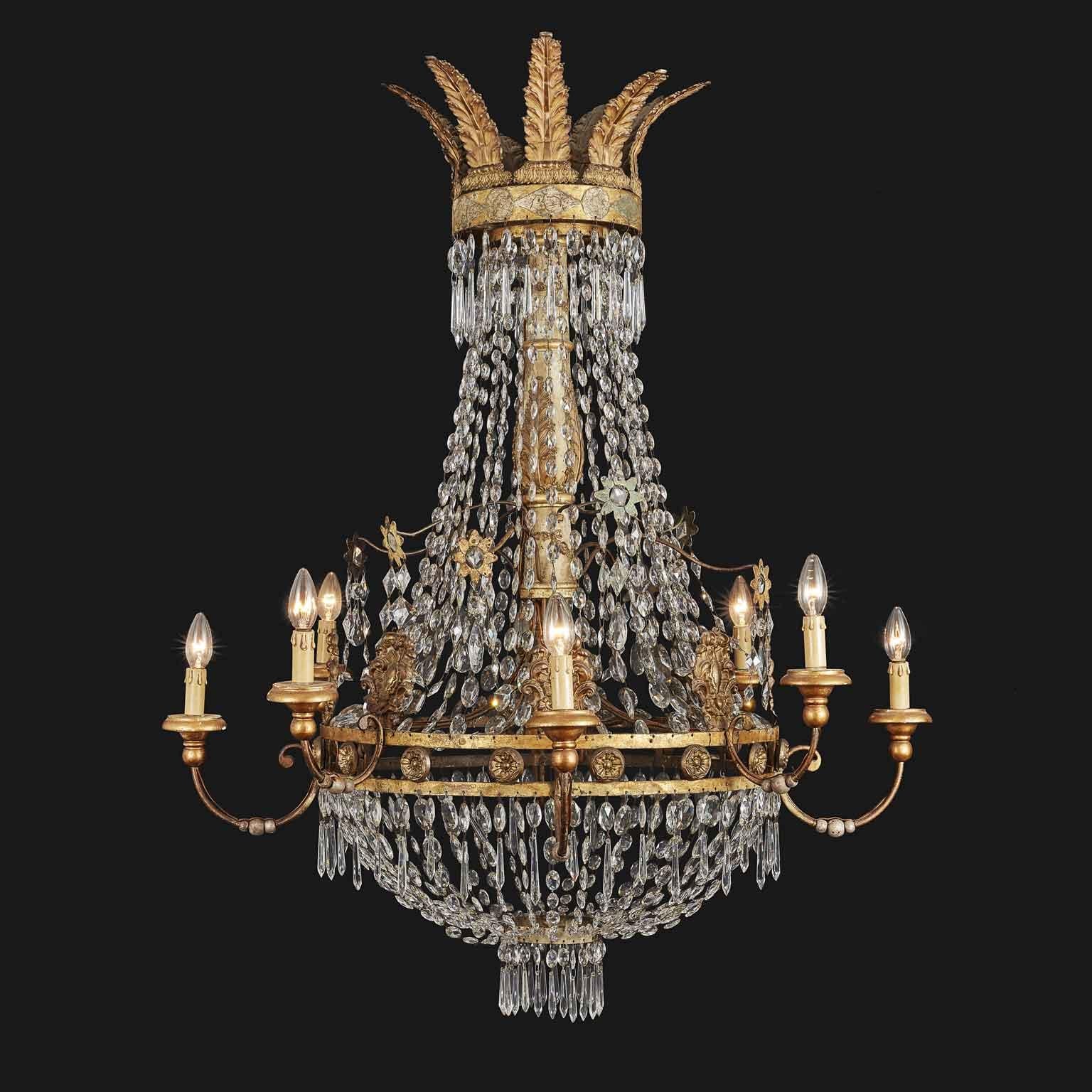 Magnificent antique Empire crystal and gilt iron chandelier, featuring two tiers supporting eight arms and hand-carved giltwood baluster stem, fully hand-made in the late 18th century of Italian origin, coming from an antiquarian in Lucca,