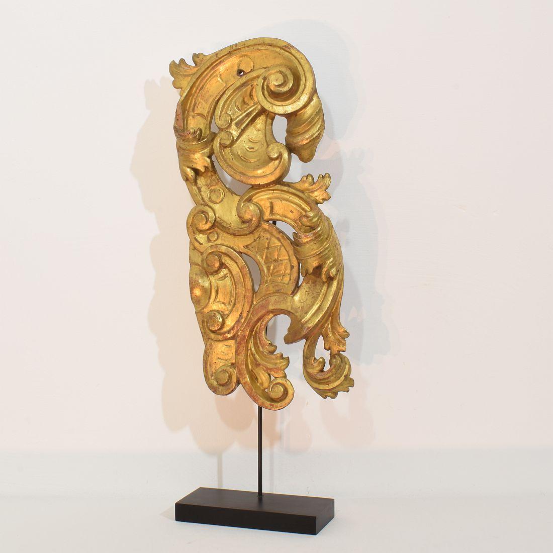 Beautiful and large handcarved giltwood baroque ornament that once adorned a chapel or a church.
Italy, circa 1750. Weathered/ small losses. Measurement includes the wooden base.
H:68,5cm  W:23cm D:9cm 
