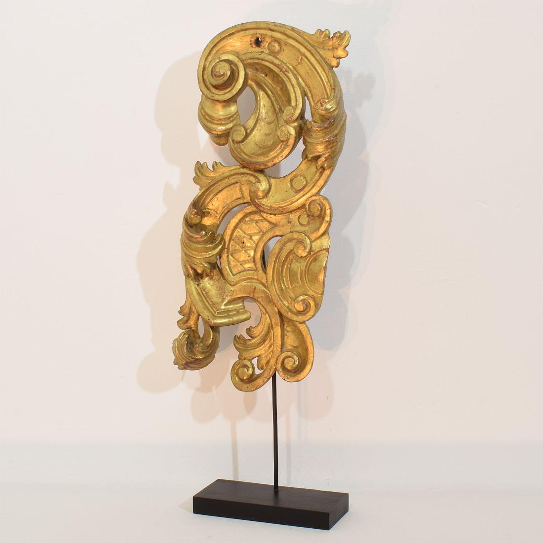 Beautiful and large handcarved giltwood baroque ornament that once adorned a chapel or a church.
Italy, circa 1750. Weathered/ small losses and old repairs. Measurement includes the wooden base.
H:54-71cm  W:23cm D:9cm 
