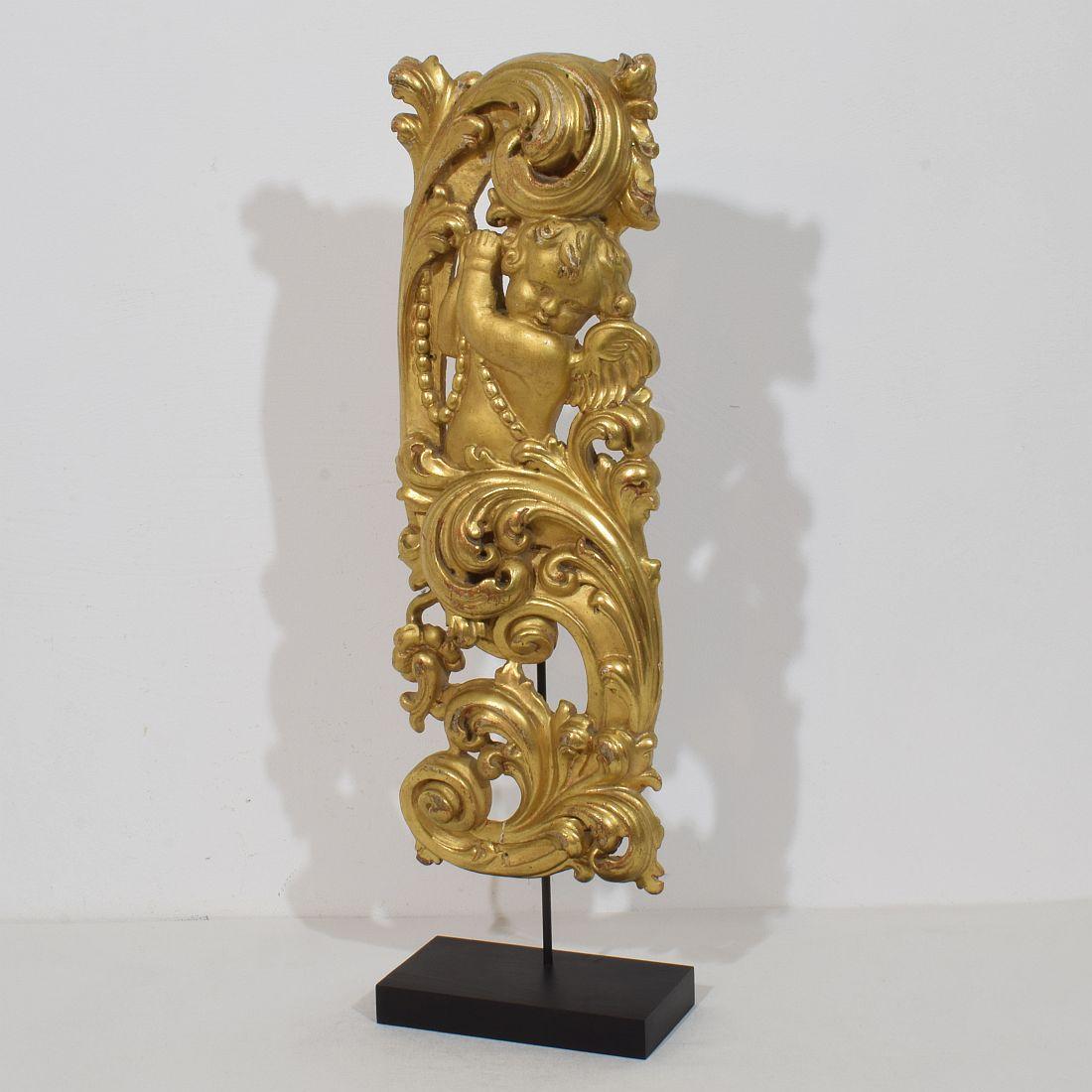 Beautiful and large handcarved giltwood baroque ornament that once adorned a chapel or a church.
It represents an baroque angel between acanthus leaves. Amazing period piece in a very good weathered condition.
Italy, circa 1750.  Measurement
