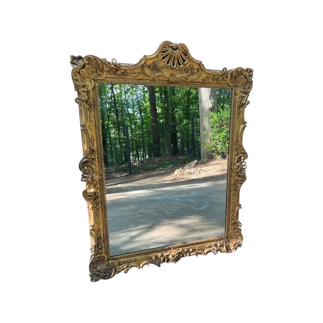 Large 18th century, Italian Rococo Gilt Wood Wall Mirror - Exhibition Label. 
Exceptional 18th century Italian School gilt wood mirror having fine pierced shell form borders. Originally this was a frame for a portrait of a Nobel man based on the
