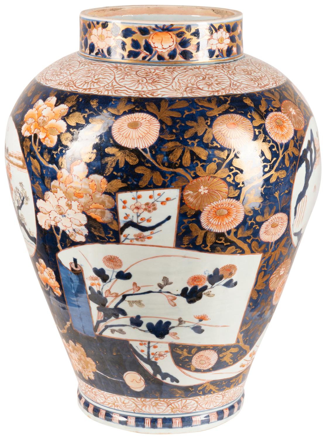 A very good quality 18th century Japanese Arita imari porcelain vase, having the Classic blue and orange round, with scrolling motif, flower and leaf decoration, inset hand painted panels depicting a pagoda building in a mountainous background with