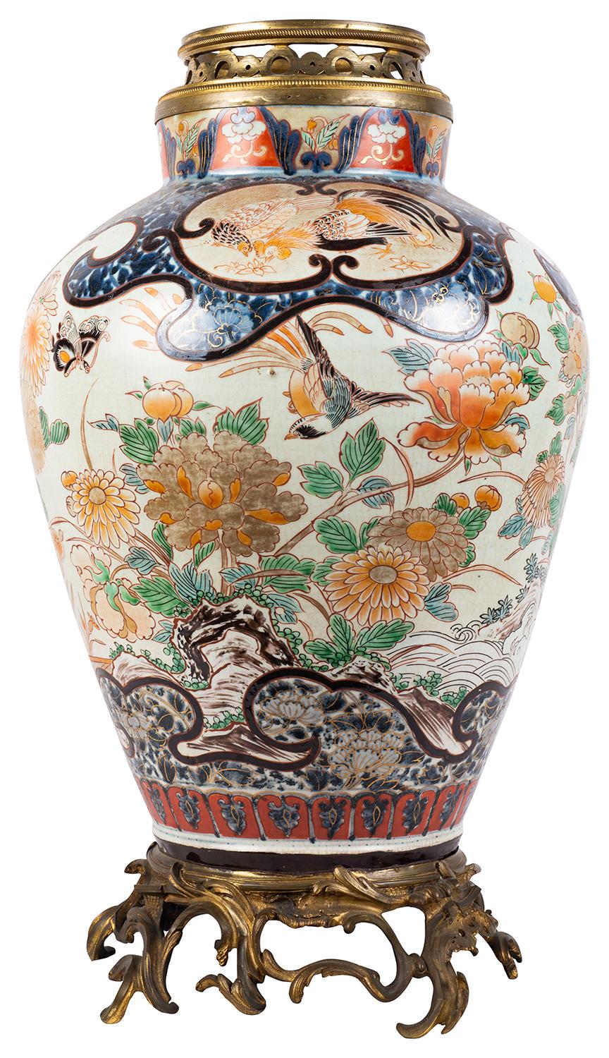 A very impressive and decorative 18th century Japanese Imari vase / lamp. Having wonderful scrolling gilded Rococo style ormolu mounts to the top and base. Classical hand painted motif decoration tooth boarders with inset panels depicting exotic