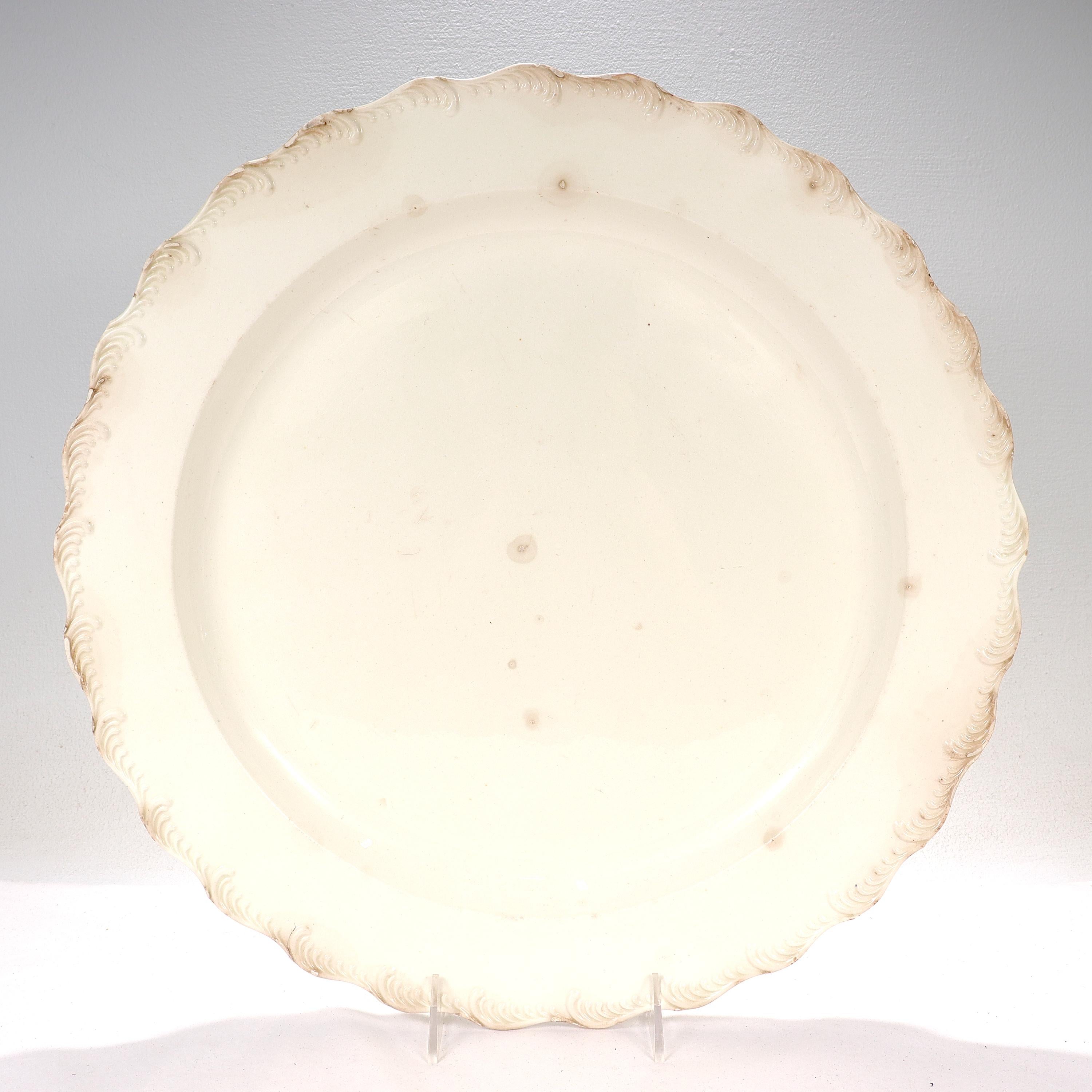 A fine, very large, 18th century English creamware pottery charger or wall plate.

With a raised feather edge border.

Simply a great antique English pottery tray or wall plate!

Date:
18th Century

Overall Condition:
It is in overall