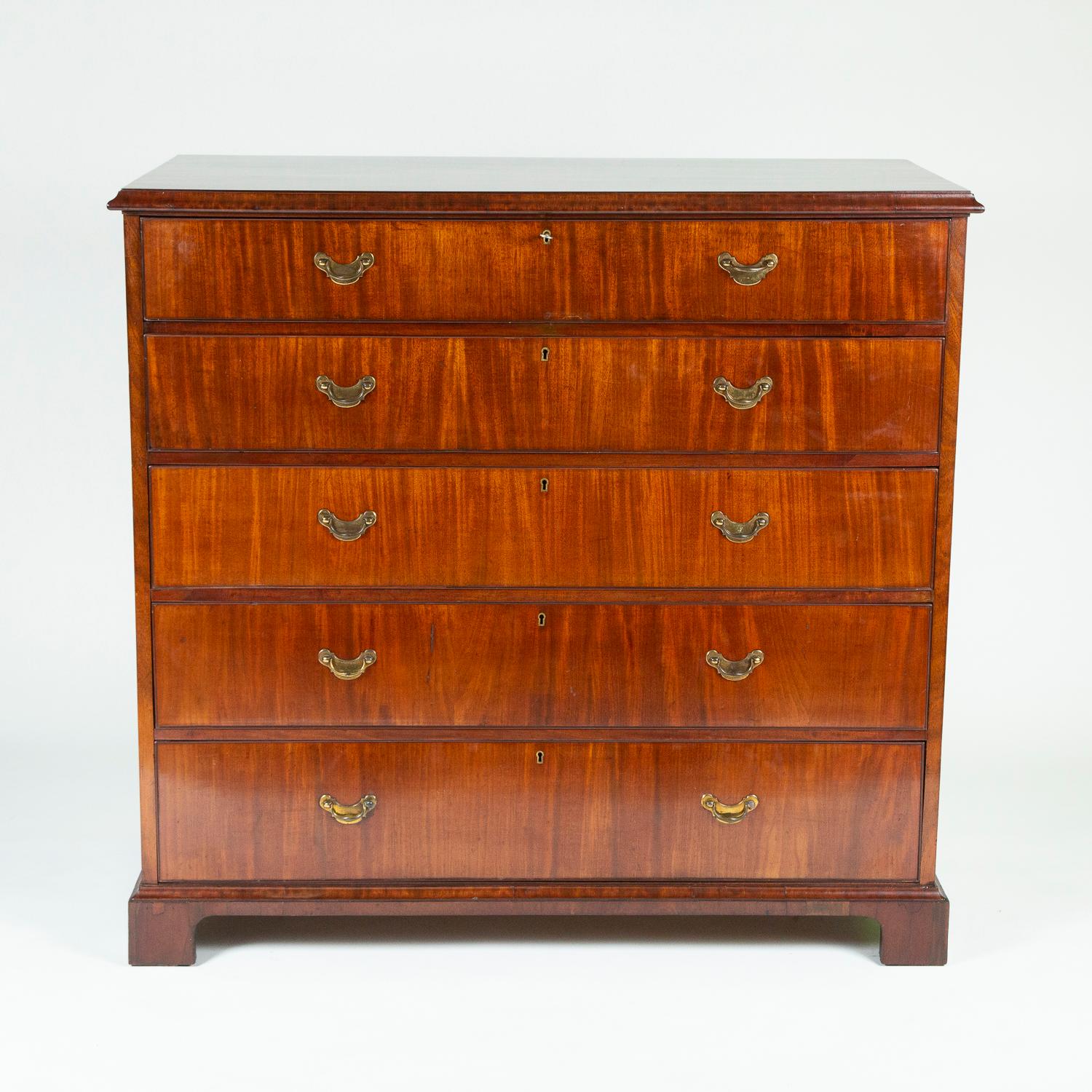 A large 18th century mahogany chest of drawers, with brass handles, and bracket feet.

5 drawers, oak lined, each with Victorian patent brass locks, top lock marked VR. 

Each side with large brass carrying handles.
 