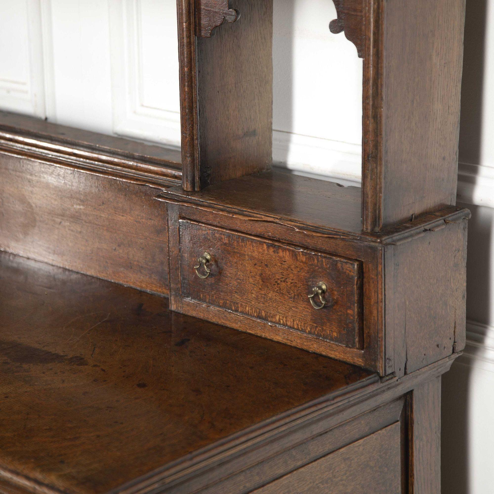 Wonderful 18th Century oak dresser.
The size of this oak dresser is wonderful and the colour and form of this dresser are just as fantastic. It is very well proportioned, having a moulded cornice on the top of two shelved plate racks. The base has