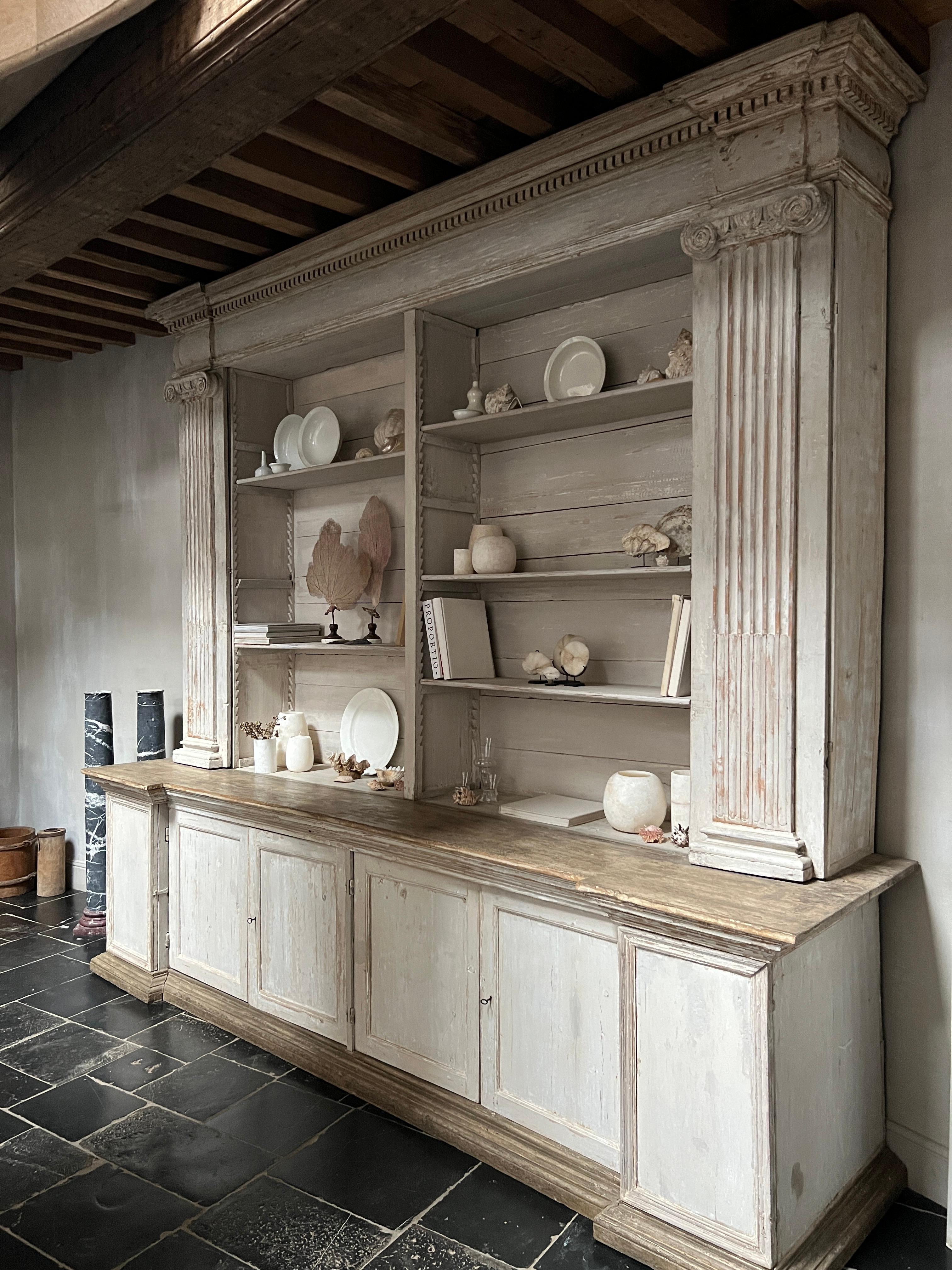 A large open display cupboard/bookcase. Made in Mantua Italy at the end of the 18th century for a monastery from local poplar and pine. Beautifully proportioned neoclassical style with ionic kapitels and fine moulding. Hidden doors in the colomns