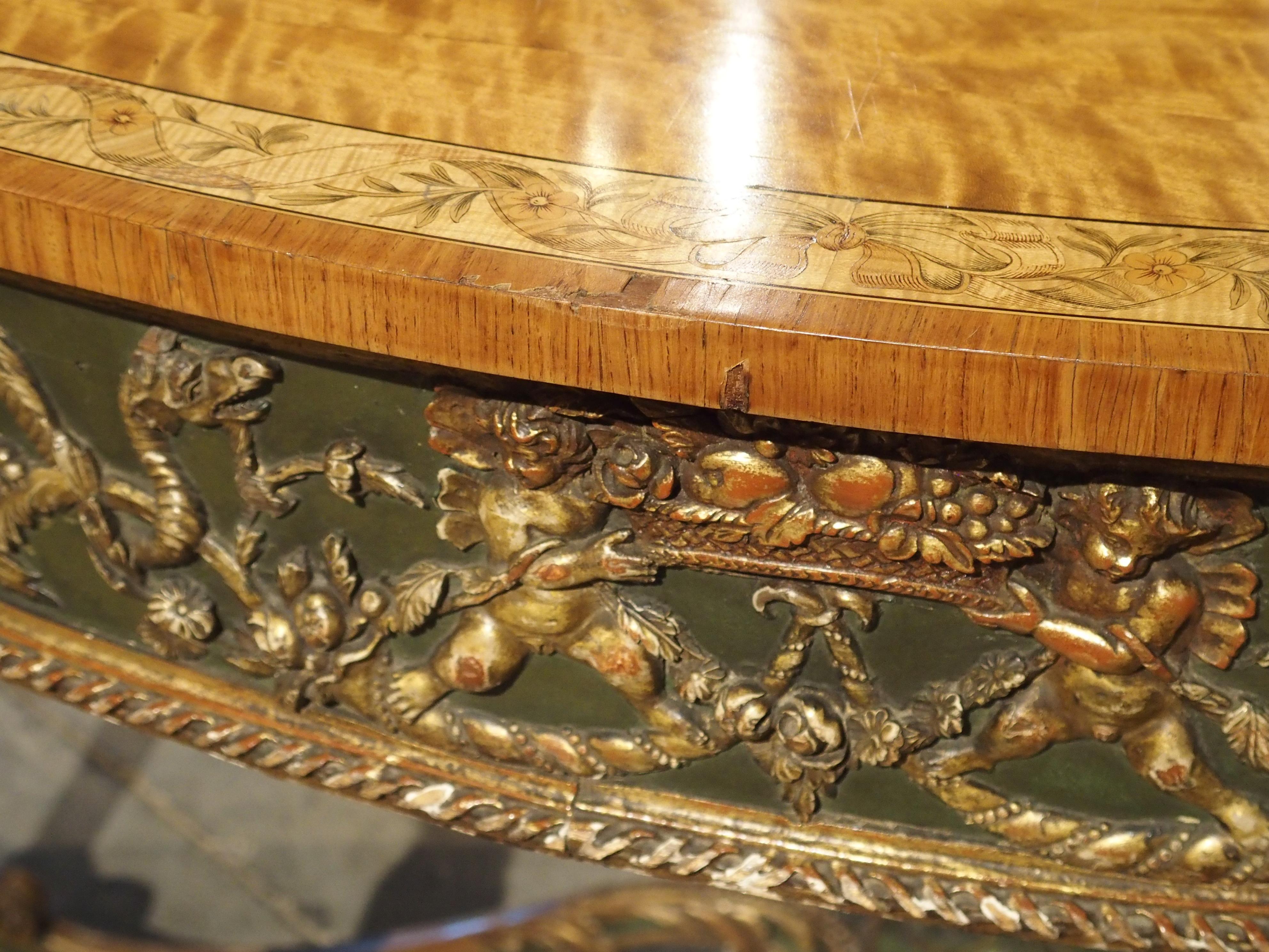 This antique Italian neoclassical console table is majestic in height, standing at over 41 inches tall. demilune in shape, this table would make a great addition to a large entryway or foyer.

Produced in the late 1700s, the console has a top made