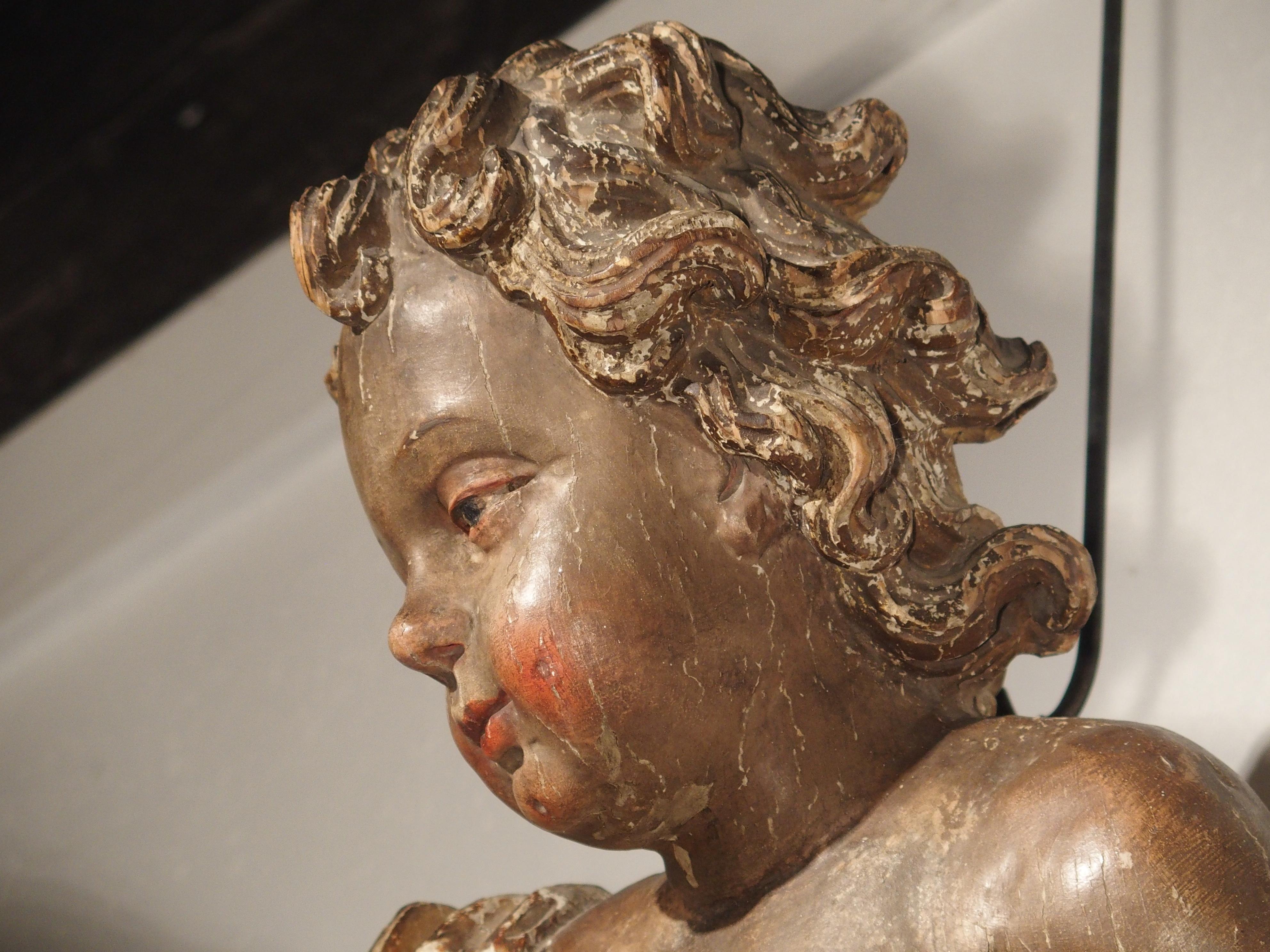 This large polychrome and giltwood cherub was produced in Italy in the 1700’s. In religion, cherubim are angels of the second highest order that serve God. During the early Renaissance and Baroque periods, artists such as Donatello began to