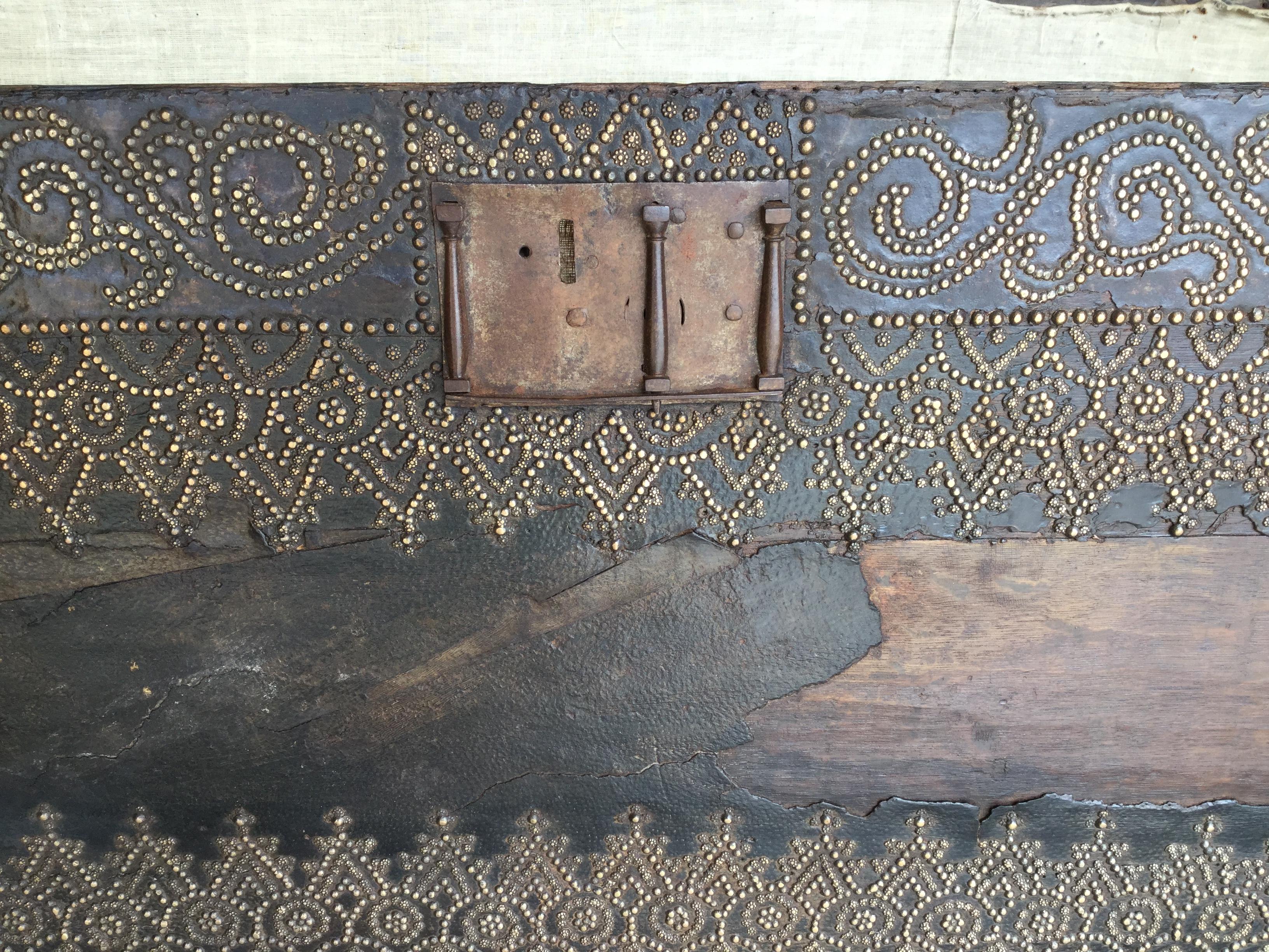 Incredible 18th century Spanish travel trunk. This trunk is enhanced by thousands of brass nails that are worked to create a Moorish pattern with scrolls and arabesques. Completely handmade, this trunk is in very good condition for its age. There