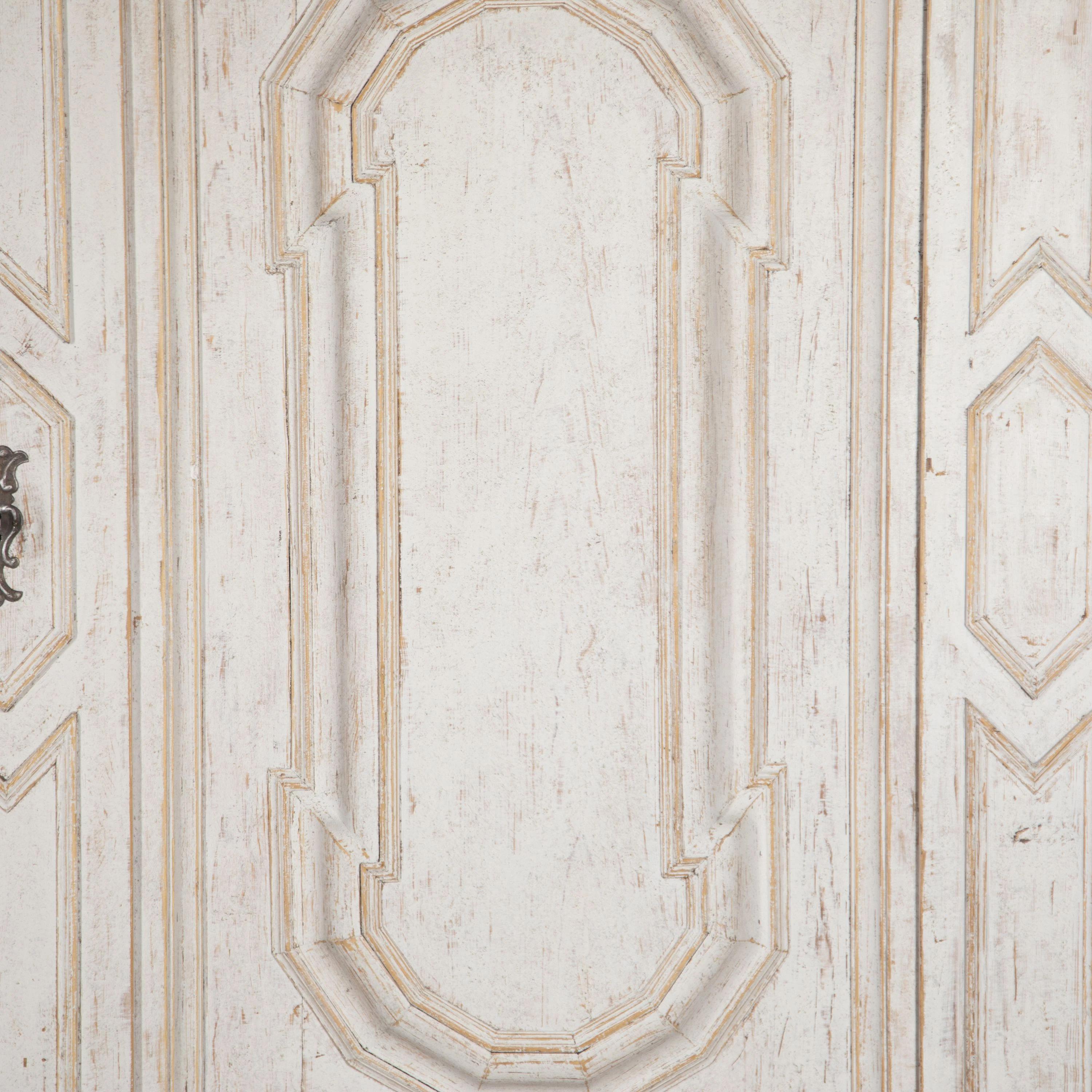 Period 18th Century Swedish Baroque cabinet. 
With a deeply carved pediment and decorative detailing on the doors. Below sit two drawers with their original loose pear-shaped feet.
Repainted in light grey. 
Circa 1740.