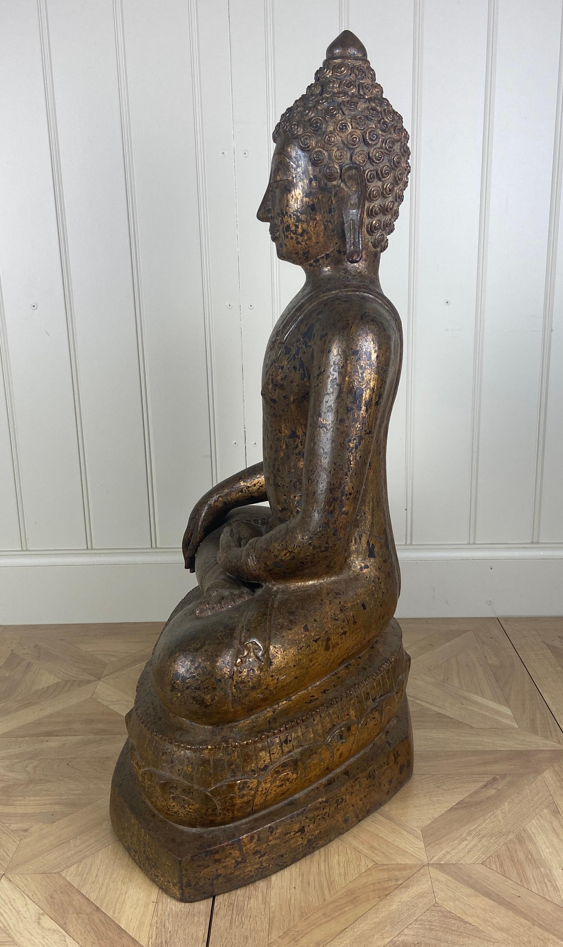 Large 18th century Thai gilt bronze seated figure of Buddha Shakyamuni
Seated in dhyanasana with hands in Bhumisparsha mudra wearing a sanghati draped over his left shoulder, the serene face with heavy-lidded downcast eyes, 80cm high, 52cm
