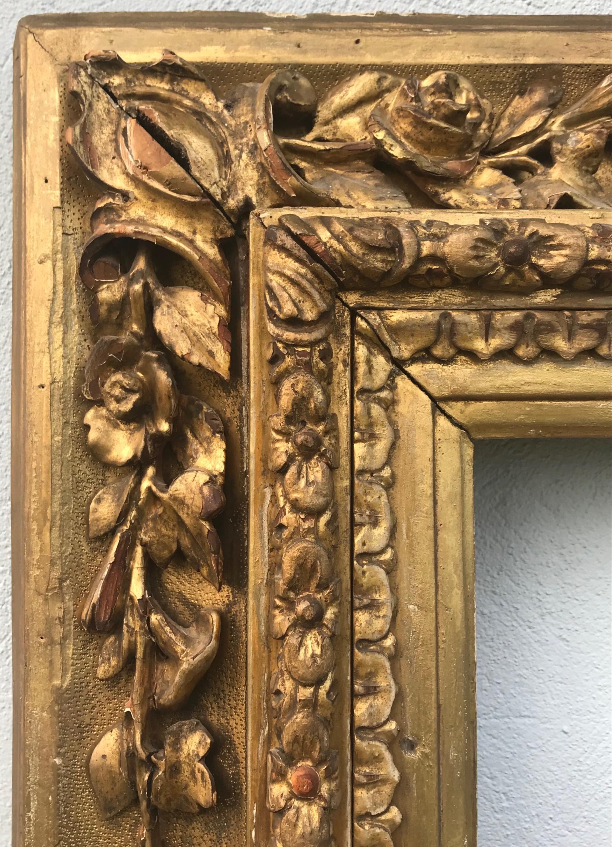 Large 18th century Venetian hand carved gilded frame

An extremely attractive antique hand carved and water gilded Italian frame from the 18th century. Created by a master carver, this frame is elaborately decorated with a finely carved variety of