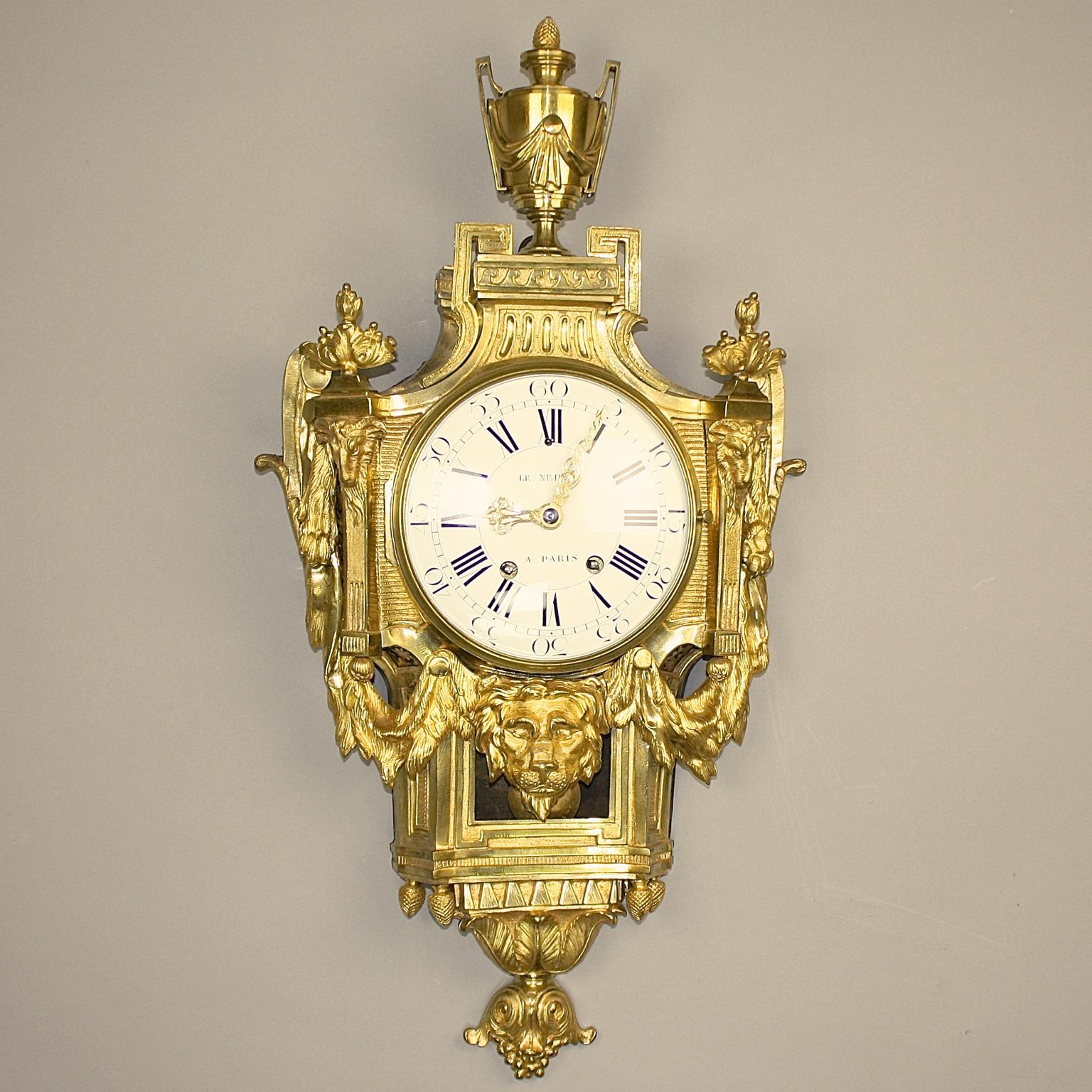 Large 18th Century French Bronze Louis XVI Lion Mask Wall Clock Signed Le Nepveu

An 18th century gilt bronze Cartel clock with a white enamel dial signed Le Nepveu a Paris, with finely pierced and engraved gilt hands, the Roman and Arabic numerals