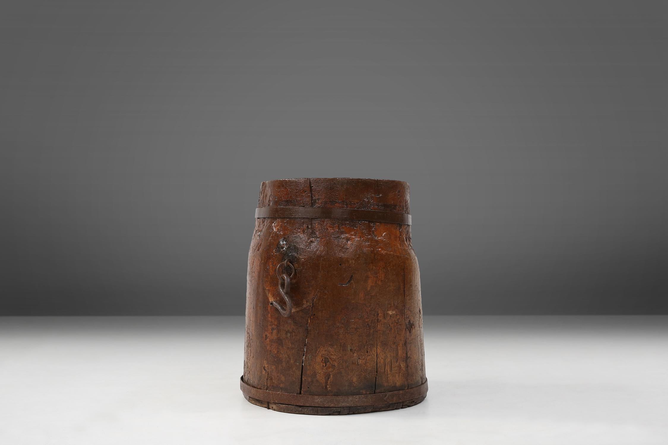 Large wooden cauldron made in France in the 18th century.

This handmade kettle is made of solid wood and metal rings. The kettle has a beautiful patina on the wood. This barrel was to be used to transport grain of the boats. You can still find