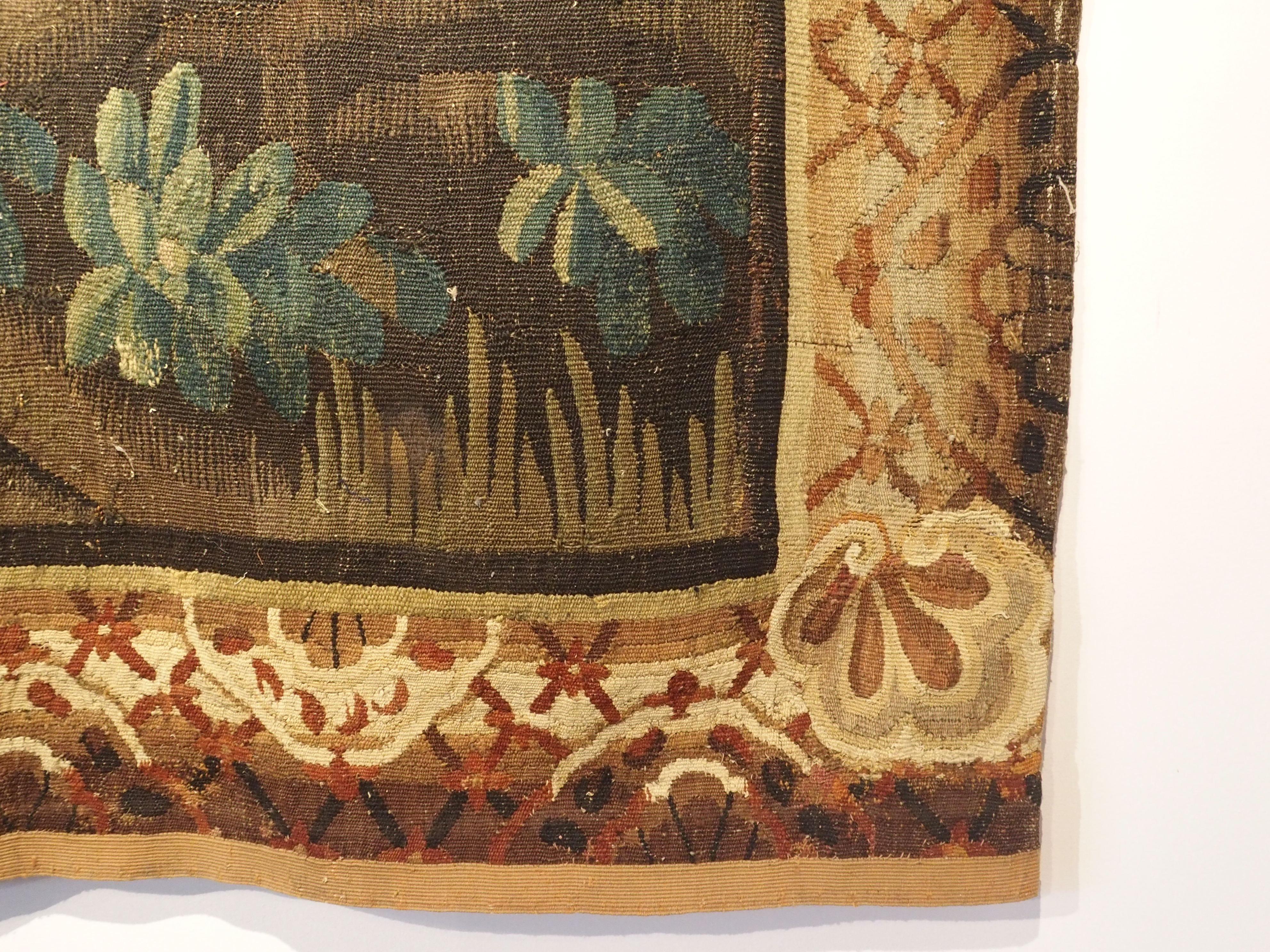 This impressive verdure landscape tapestry, made from wool and silk dates to the 18th Century and is from Flanders, or approximately, present day Northern France and Belgium. Along with the usual colors associated with verdure tapestries, this piece