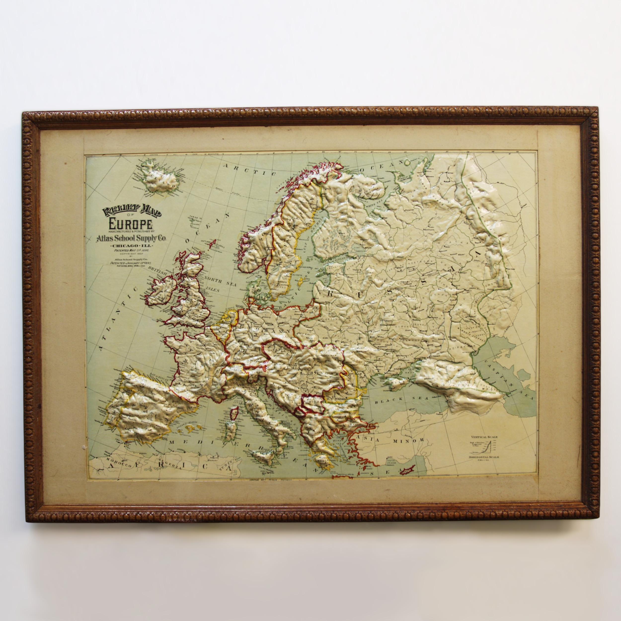 Remarkably original, 1907 Relief map of Europe by the Atlas School Supply Co. of Chicago, Illinois. This exceptional quality map features its original oak frame, heavy-duty stretcher, bold graphics and beautifully molded 3-D papier-mâché topography.