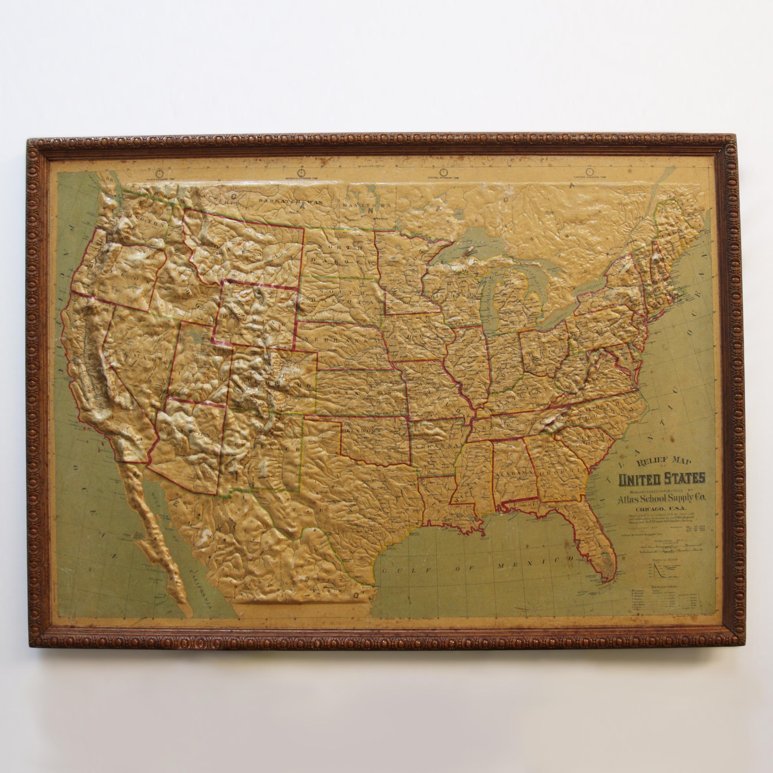 Remarkably original, 1907 Relief map of the United States by the Atlas School Supply Co. of Chicago, Illinois. This exceptional quality map features its original oak frame, heavy-duty stretcher, bold graphics and beautifully molded 3-D Papier-mâché