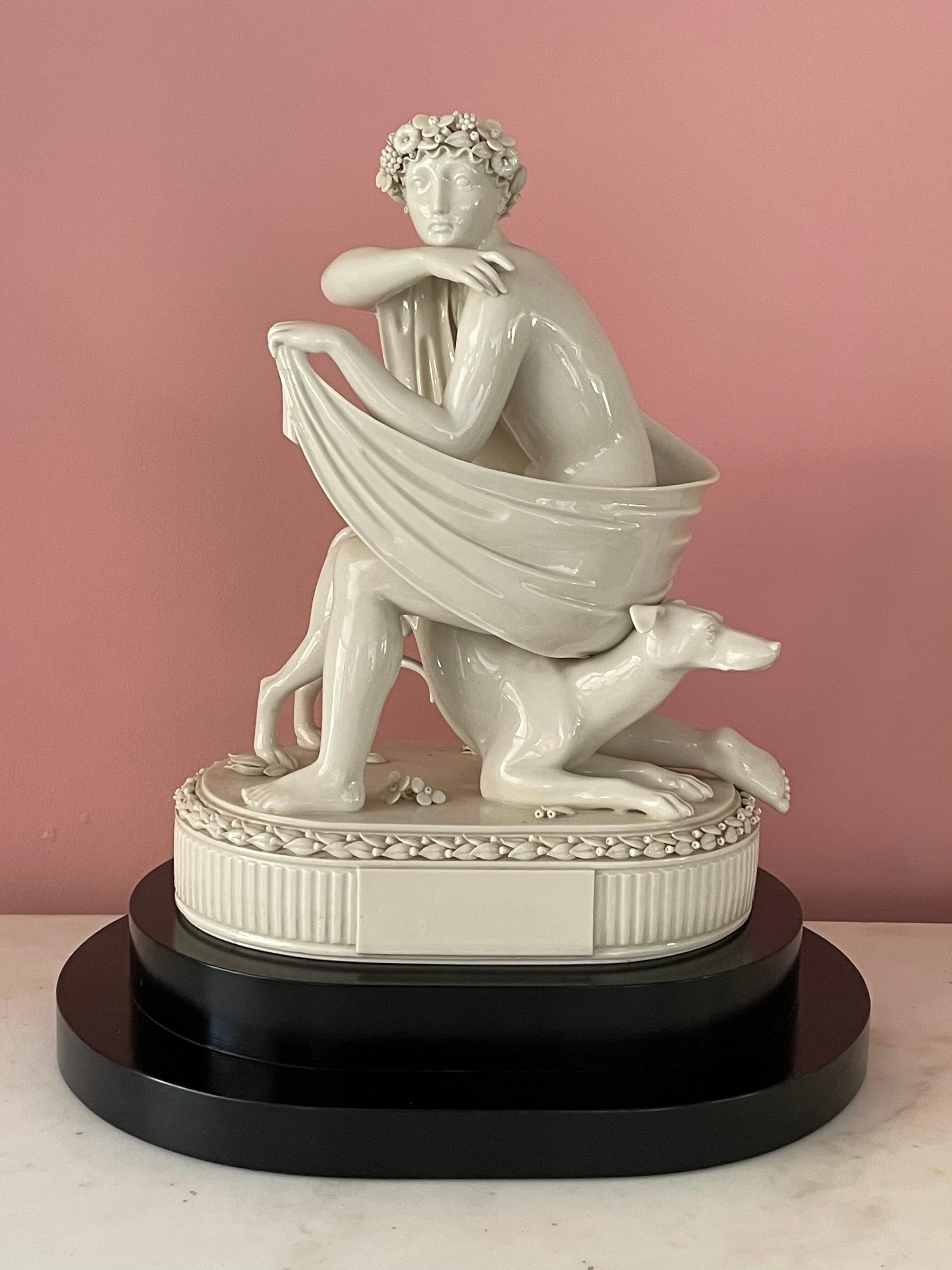 This 1927 Royal Copenhagen porcelain sculpture is exceptionally large in scale, and appears to represent an Amazon with her hound. It is remarkable for the juxtaposition of the simplified forms of her limbs and base, seen in the carefully detailed