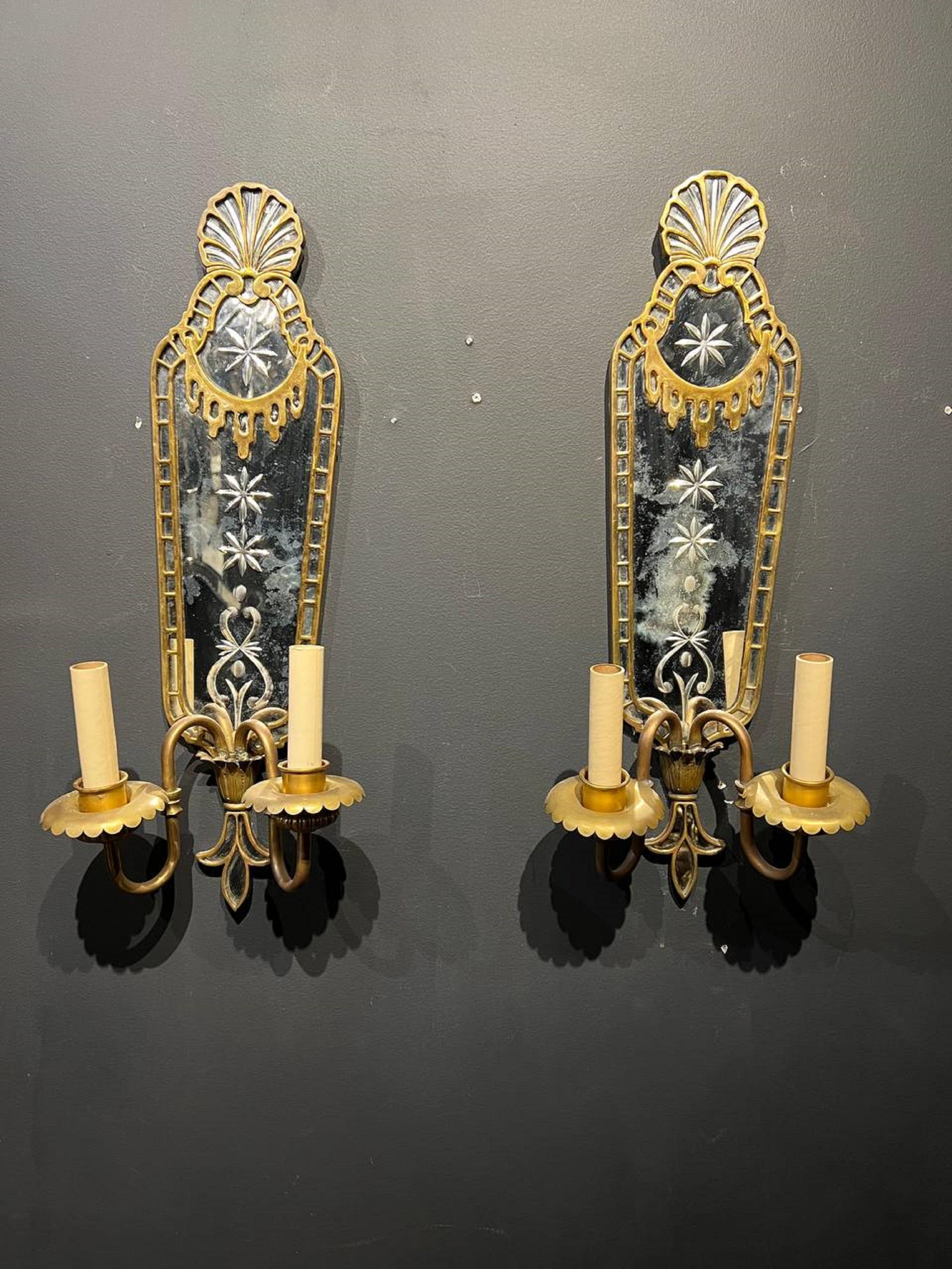 A pair of 1920’s large mirrored back plate sconces with bronze fittings and two lights. In very good vintage condition. 

Dealer: G302YP 
