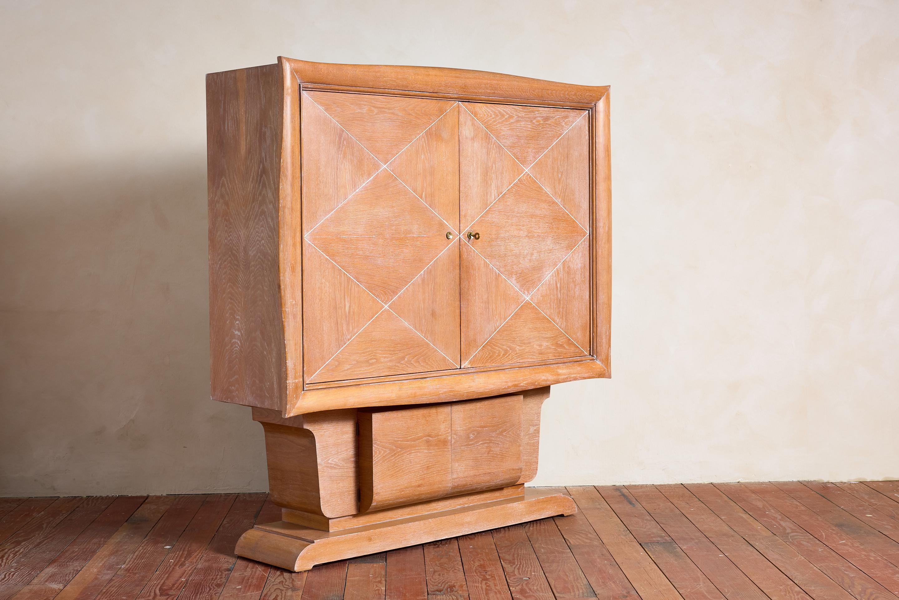 Massive Art Deco Cabinet  - France, circa 1930s

Cerused oak wood with diamond detailing on doors. 

Floating on pedestal with swinging doors opening for storage.

Impressive in scale and stunning shape. 

