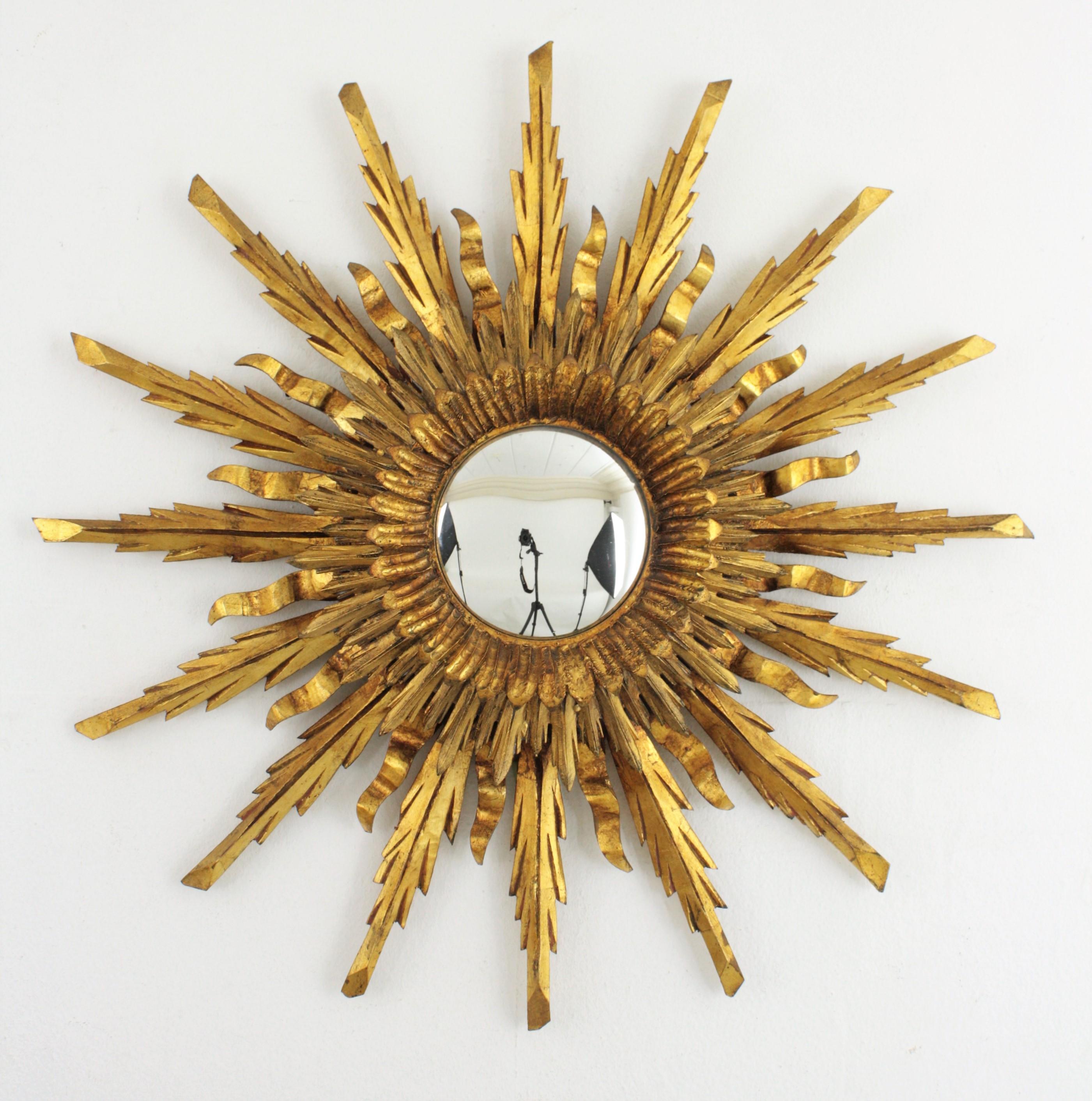 An spectacular gold leaf gilt sunburst flush mount or ceiling light fixture in Baroque style made in Spain, circa 1930-1940. Large size with two layers of beams in different sizes that make this piece gorgeous and highly decorative even more face to