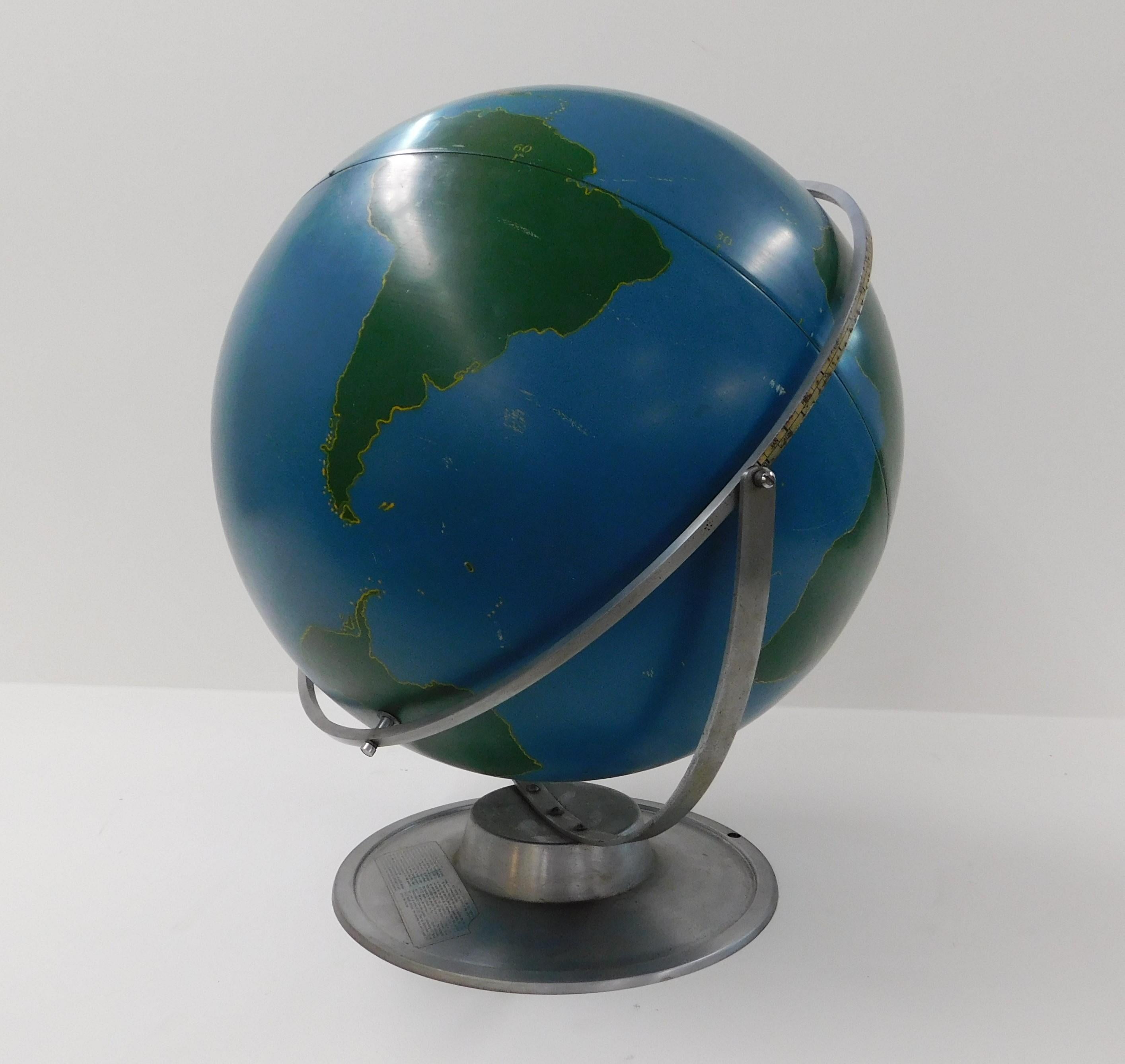 Large lacquer over aluminum rotating and swivel aviation military training globe on an aluminum base, strong steel construction circa 1940 manufactured in Chicago Illinois. These were designed to be written on with chalk to depict and train for