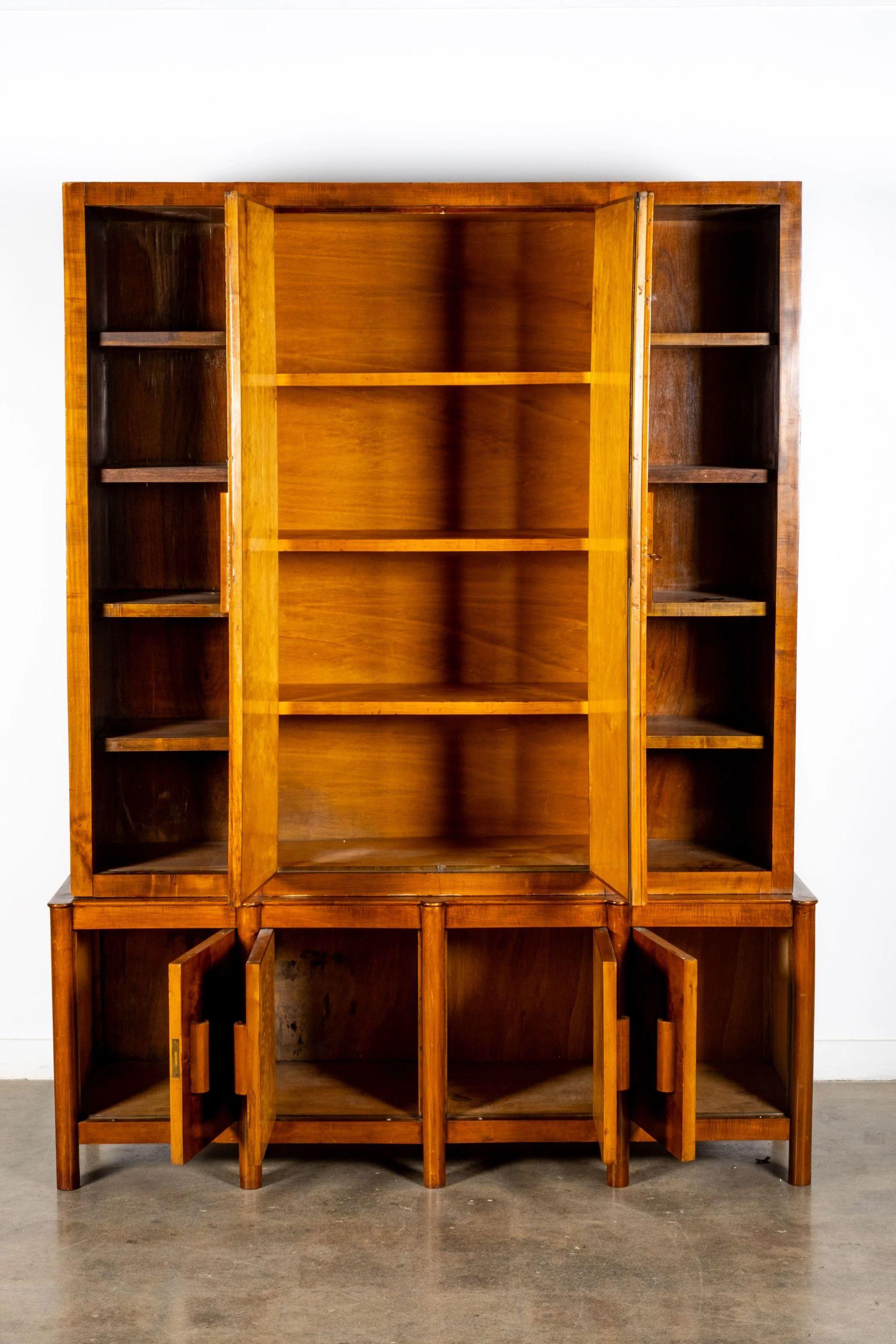 Italian armoire gives new meaning to the word ‘grand.’ Dating from about 1940, it has a mix of open storage and cupboards. Intricate grain patterns of the burl wood make this a piece to savour slowly. Natural wear due to age throughout, with light