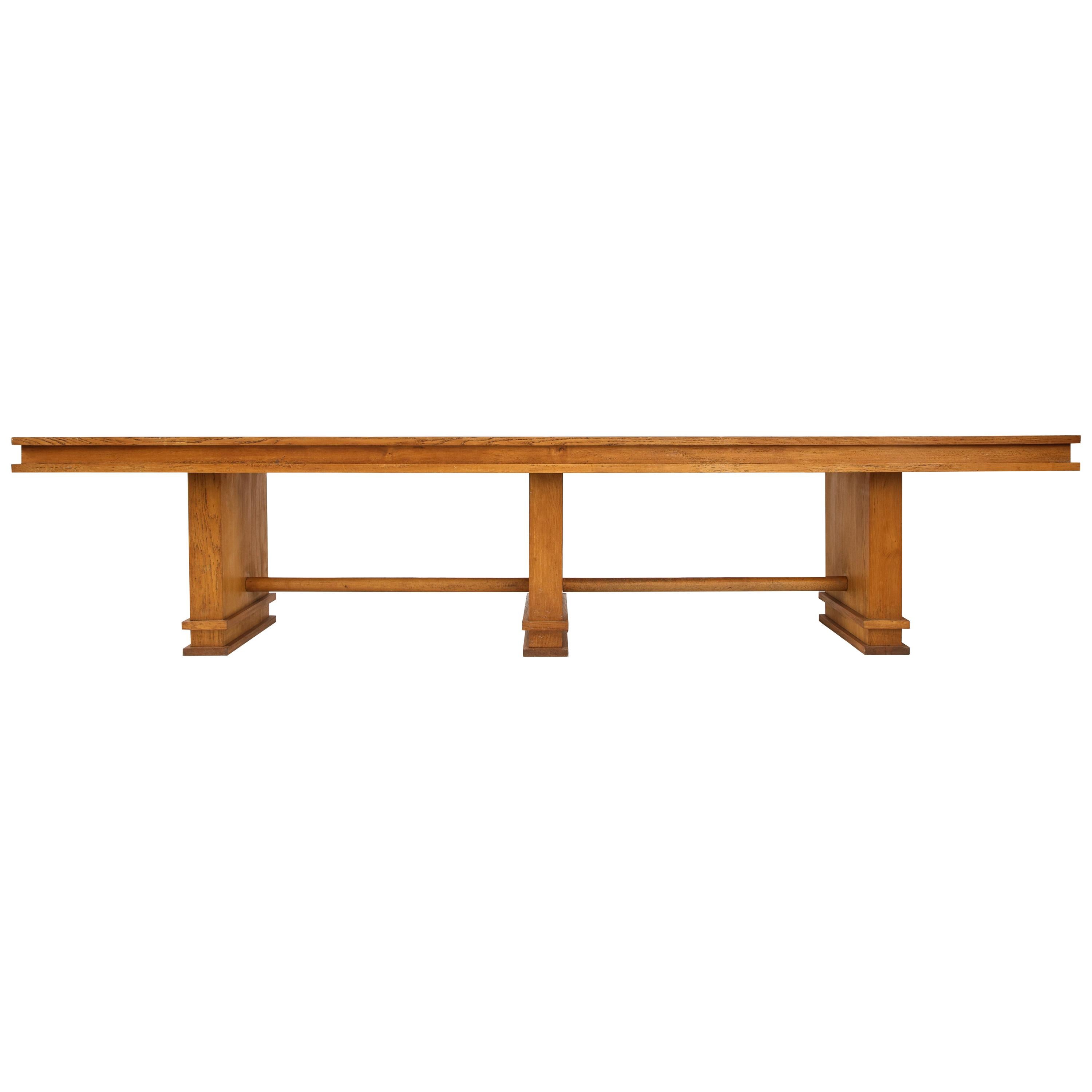 This monumental piece is broad and muscular. Defined by simple stately geometry. It will serve well as a large console, entry table, library table or shallow dining table. 

It is possible to replace the green laminate panels with leather, parchment