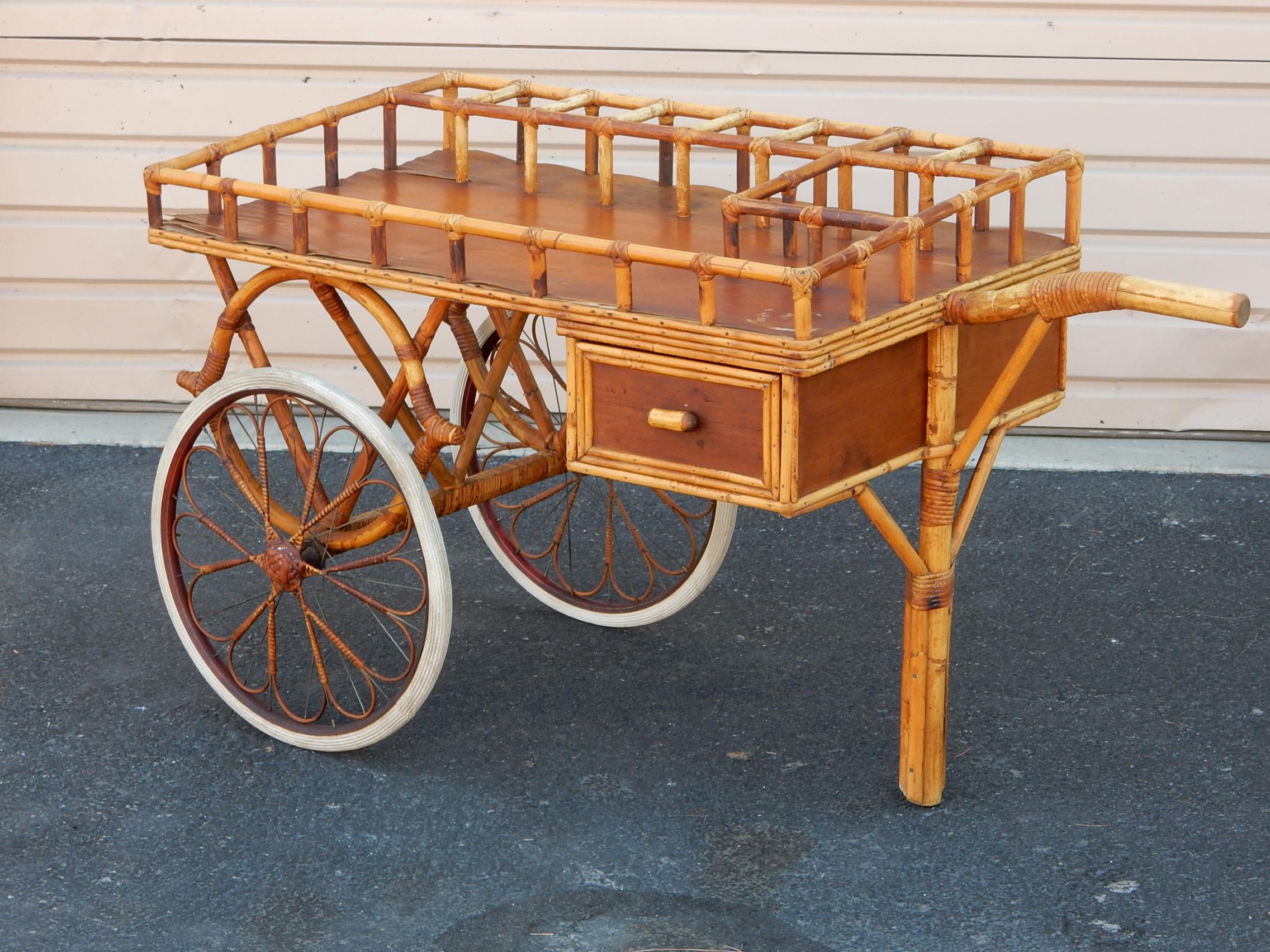 Large serving bar cart formed of rattan and cane wrapping, circa 1940's.
Every part of this piece was hand crafted & designed by a Japanese artisan. It's fabulous! 
8 separate 4in X 4-1/2in decanter areas and one larger for ice bucket or? 
One