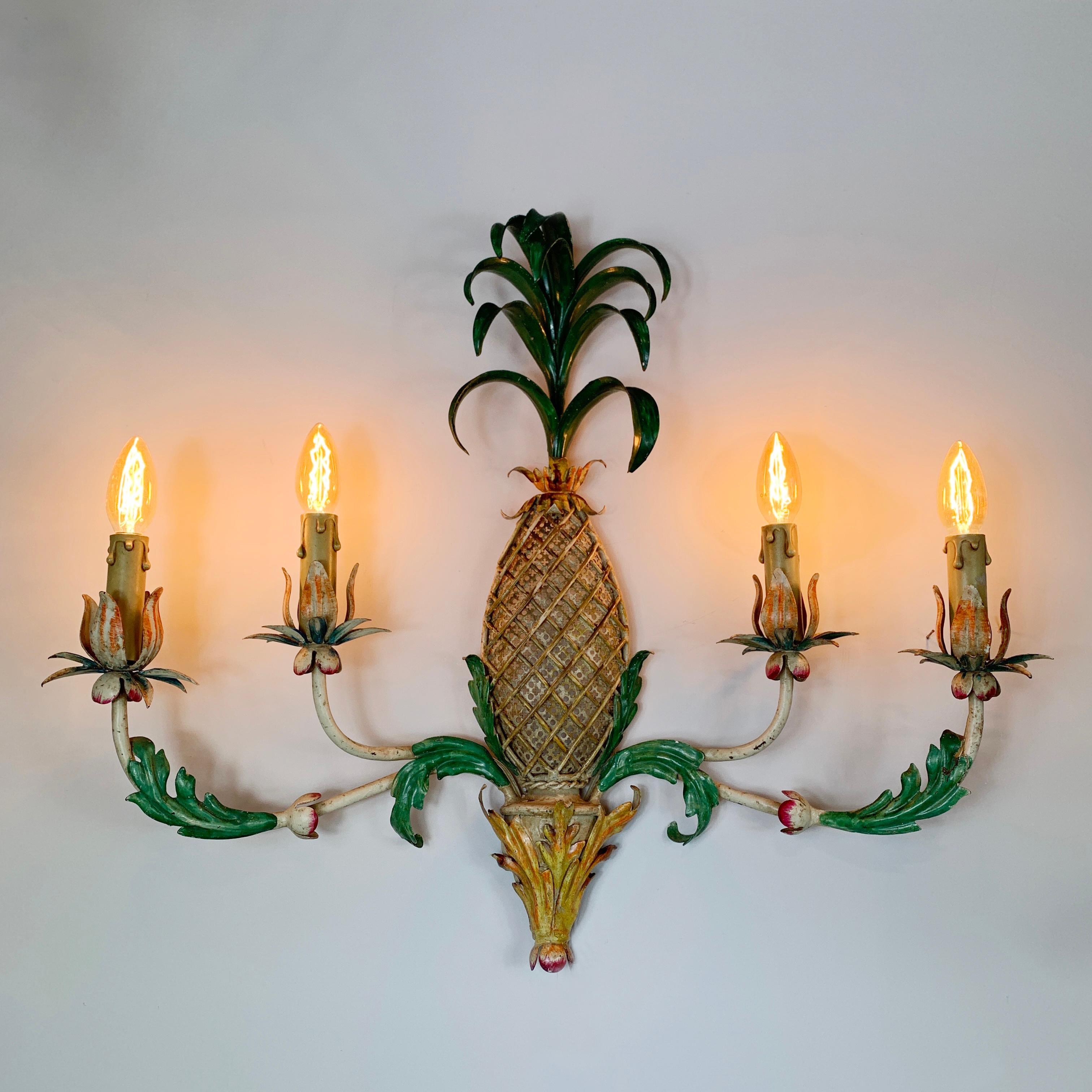A large 1940's tole pineapple wall light, hand painted, French. This beautiful and unusually decorative light, has a pierced metal work central pineapple, with four branched arms extending outward which house the bulb holders, which in turn are