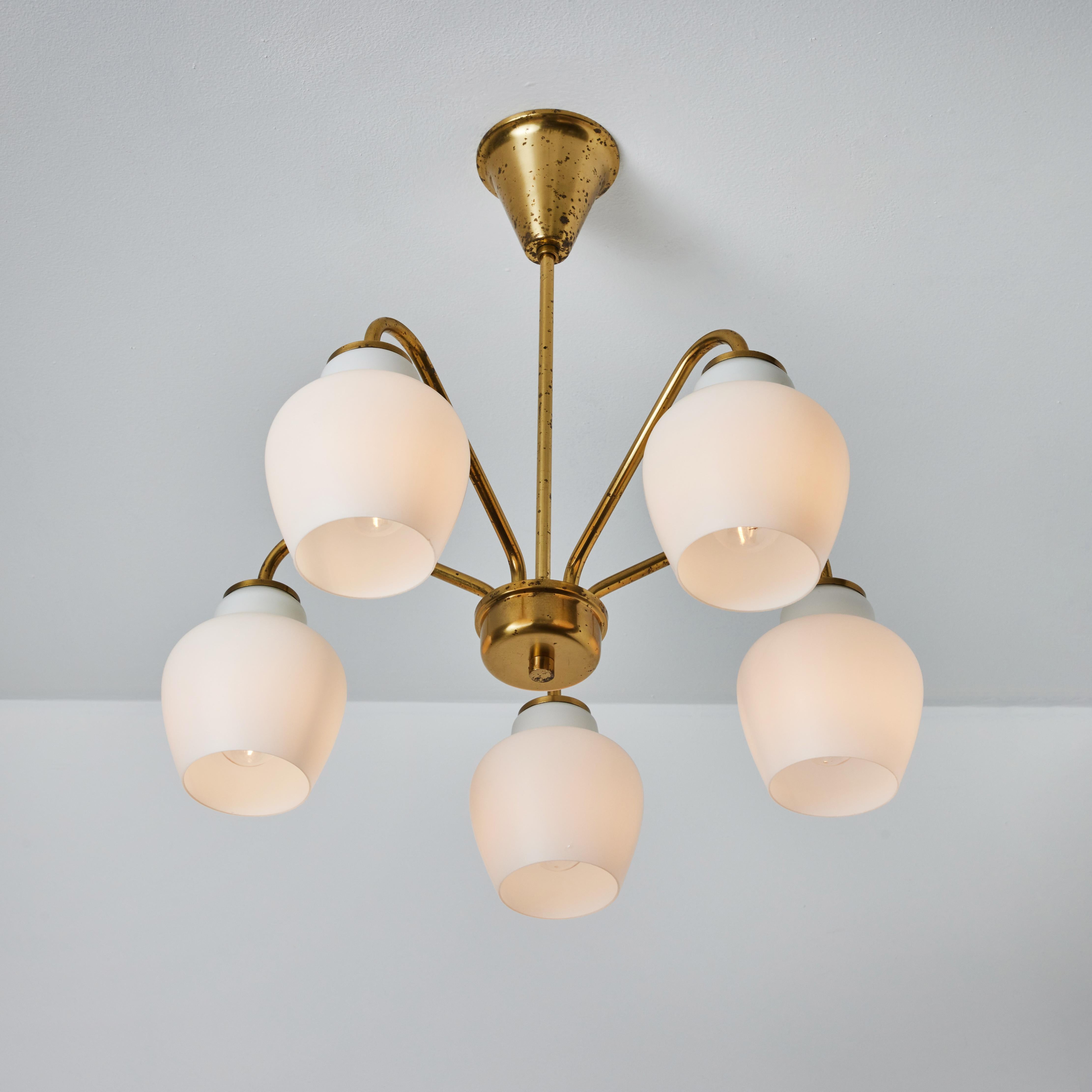 Large Bent Karlby 5-arm glass and brass chandelier for Lyfa. Executed in patinated brass with five opaline blown glass shades, Denmark, circa 1950s. A quintessentially Danish Modern chandelier by a master designer whose exquisitely crafted pieces