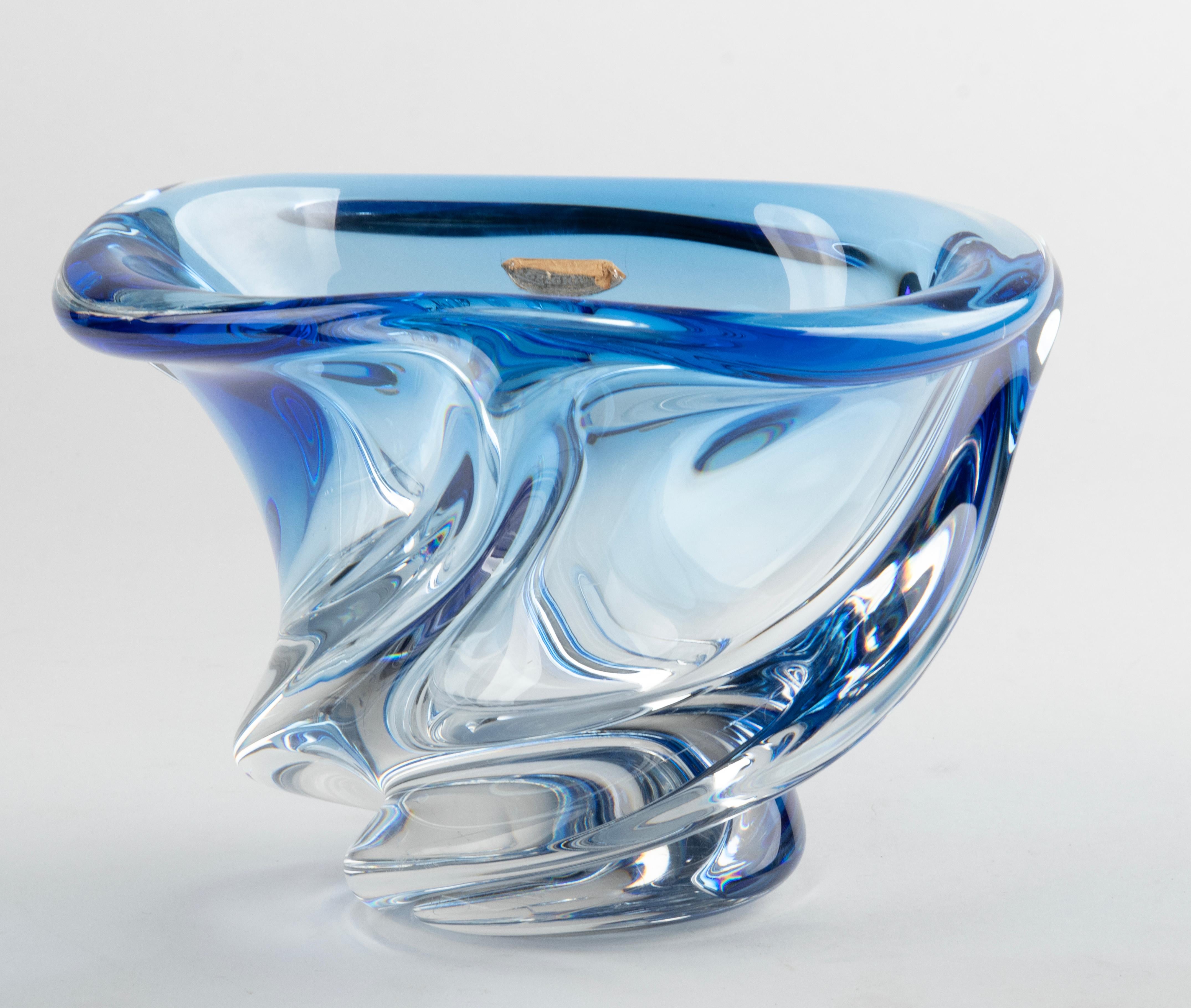 Large crystal vase from the Belgian brand Val Saint Lambert. The vase is signed on the bottom. The vase has a thick wall and is of a heavy quality. This piece dates from circa 1950. Beautiful bright blue color and a free form.
The vase is in very
