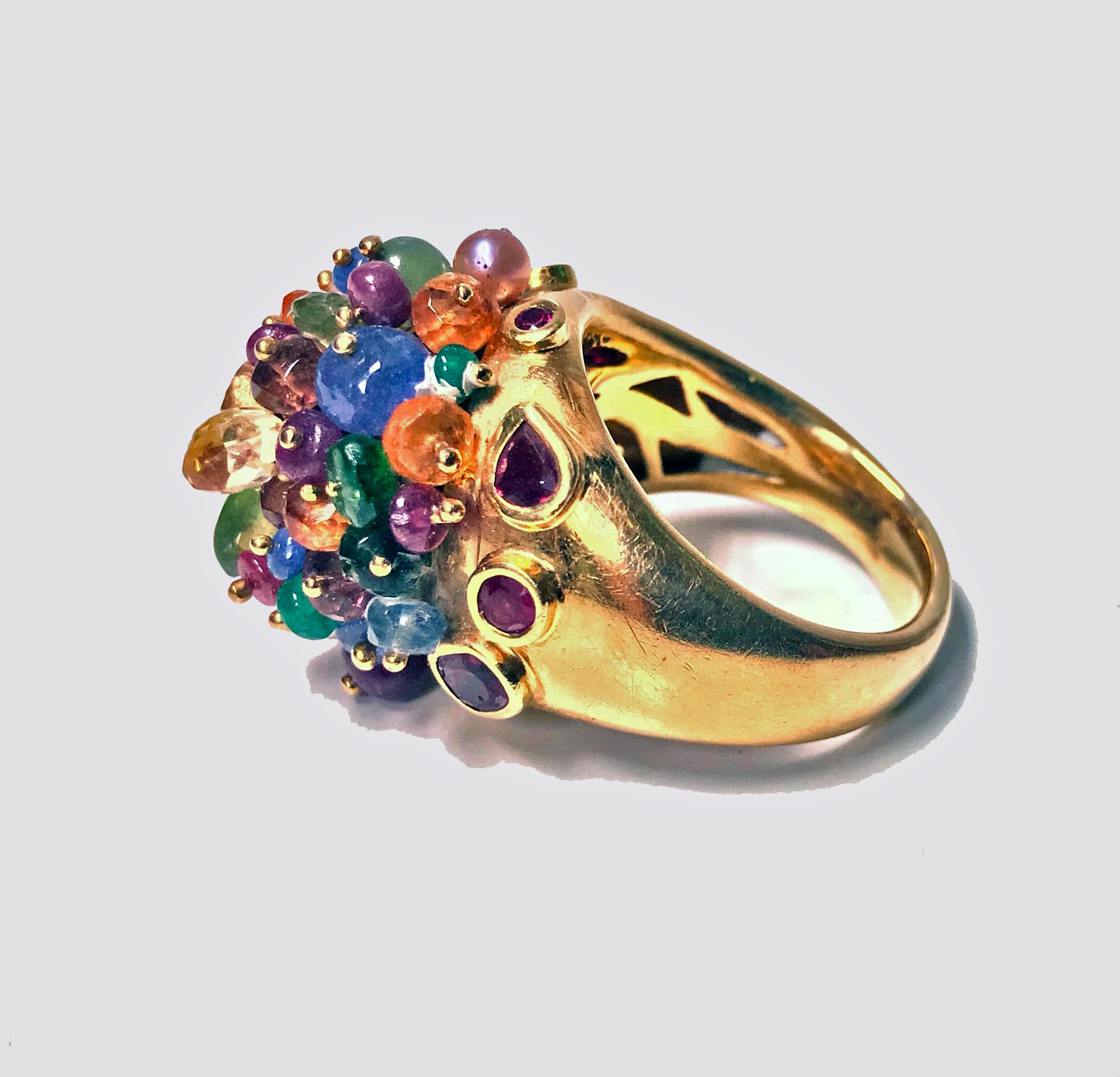 1950’s French 18K multi gem tutti frutti dome cocktail Ring. The dome shaped ring set with multi gemstones including, diamond, ruby, sapphire, pearl, emerald, quartz and peridot. Beautiful carving to under bezel gallery mount.  French export mark