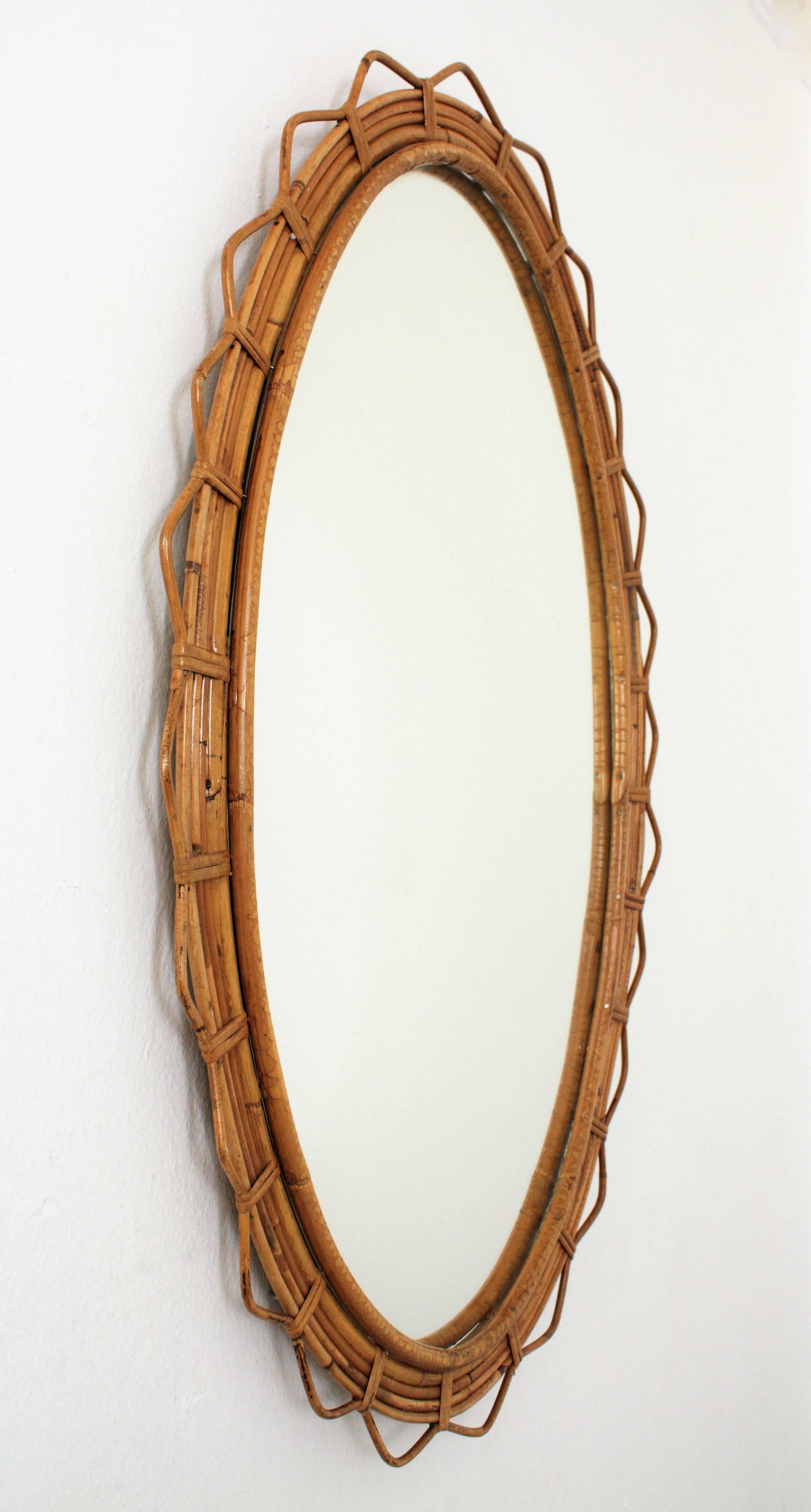 Hand-Crafted Large 1950s French Riviera Bamboo and Rattan Jagged Edge Oval Sunburst Mirror