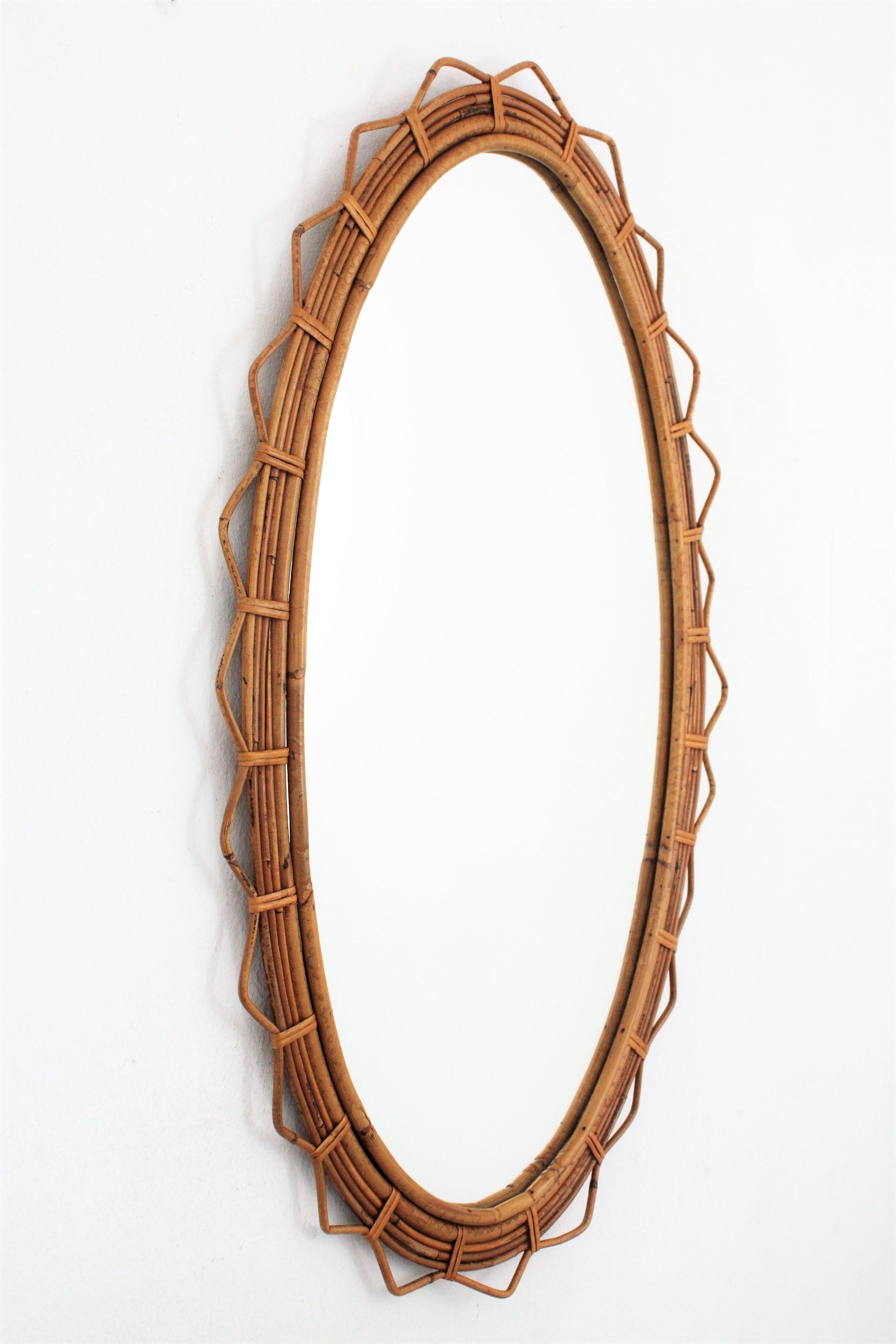 Hand-Crafted Large 1950s French Riviera Bamboo and Rattan Jagged Edge Oval Sunburst Mirror