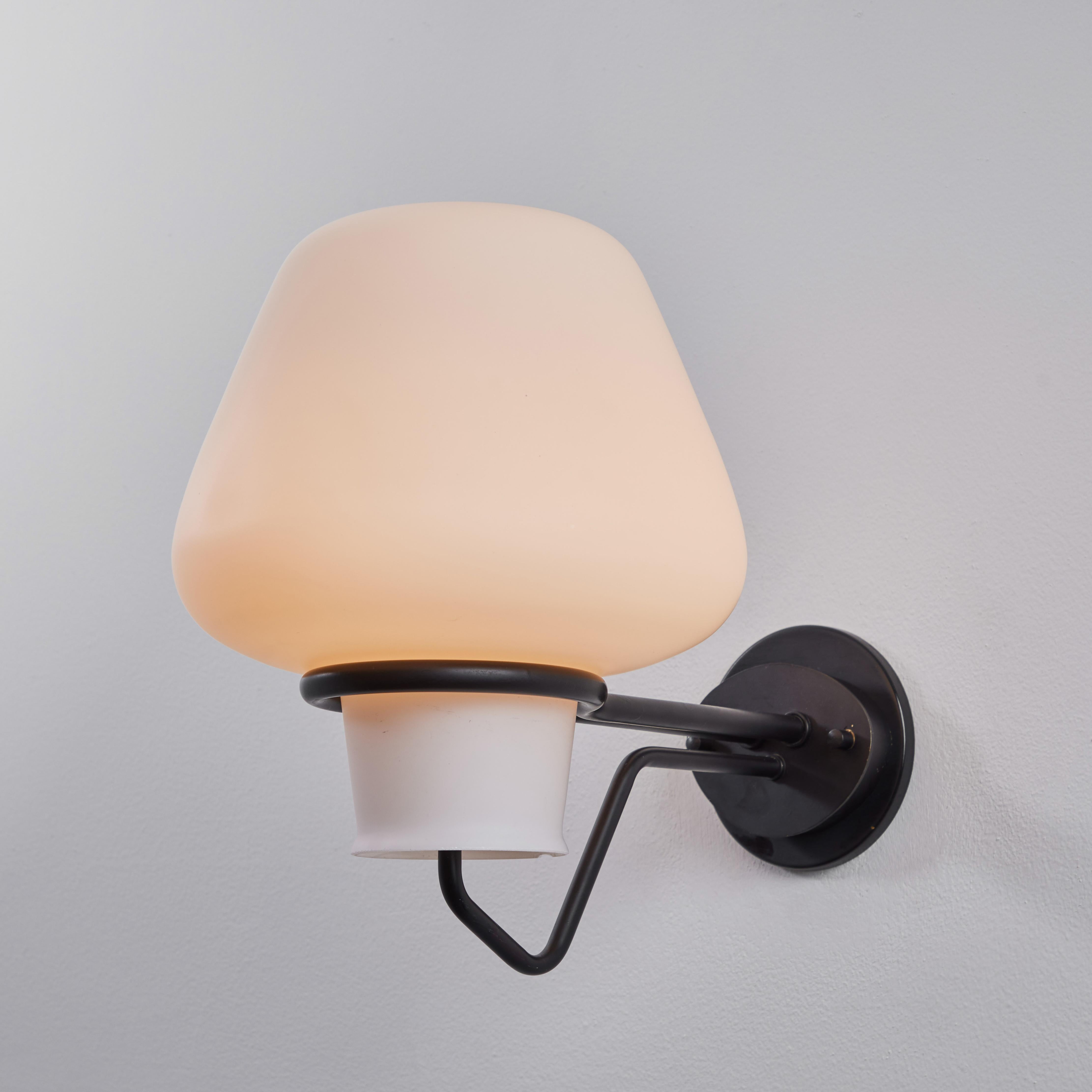 Large 1950s Gunnar Asplund JH-813 metal and glass sconce for ASEA. Executed in black painted and opaline glass with custom period style backplate added for mounting over a standard American j-box. A lyrical and elegant Scandinavian modern design