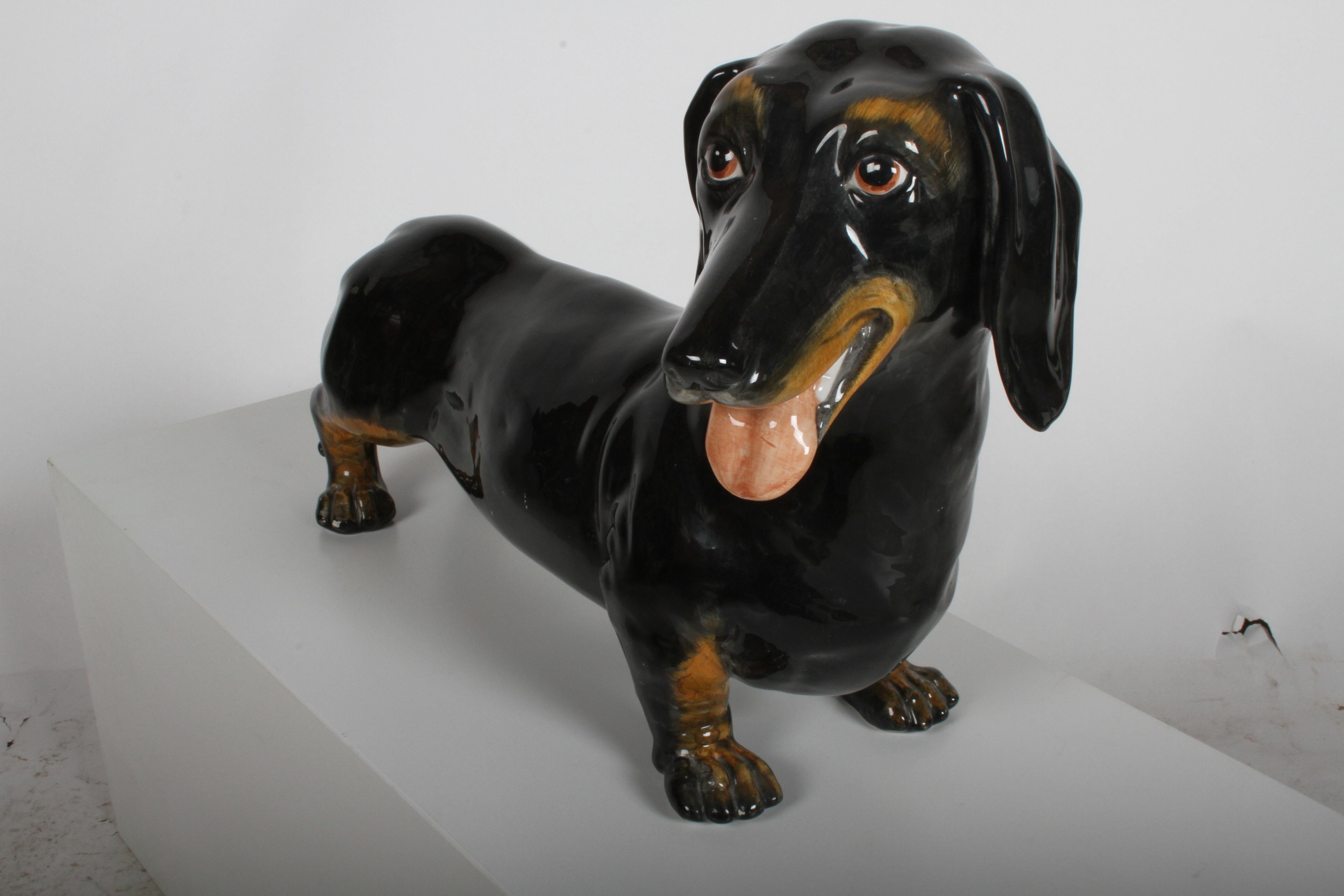 Midcentury Italian intricately cast and hand painted Dachshund dog with lovely details and an endearing demeanor. Minor scuffs or flea bites to surface. Can be touched up. No cracks or repairs. Marked made in Italy.

           