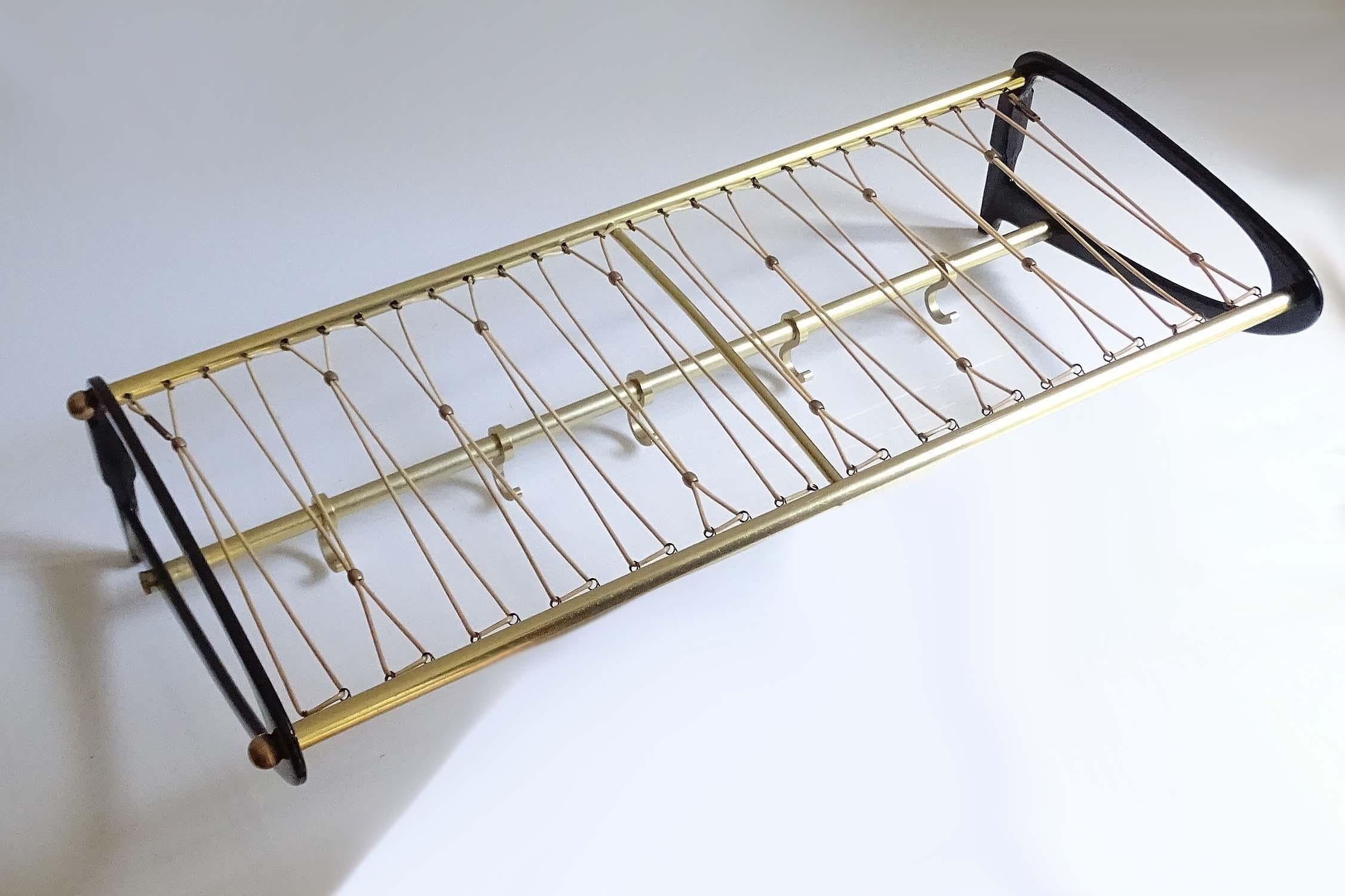 Original midcentury French wall-mount coat and hat rack, very elegant swooping design, made out anodized and black enameled aluminium with brass trim and five sliding coat hooks, unusual hat rack made out a zig-zag nylon coated net with punctuated