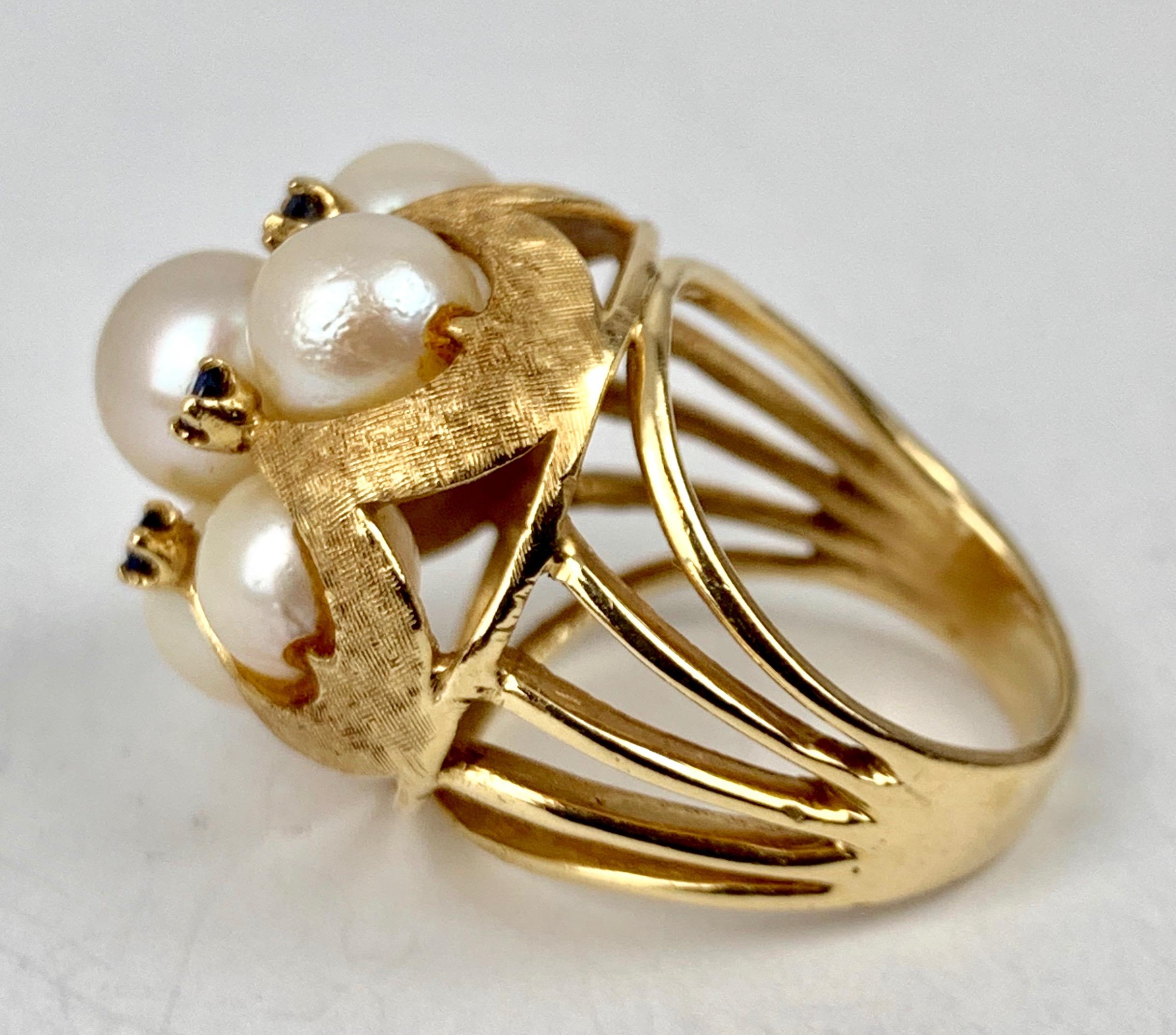 Cluster pearl and sapphire cocktail ring set in 14 karat yellow gold.  There are six lustrous pearls and five sapphires.  The gold retains the original Florentine finish that was custom made for my client.  