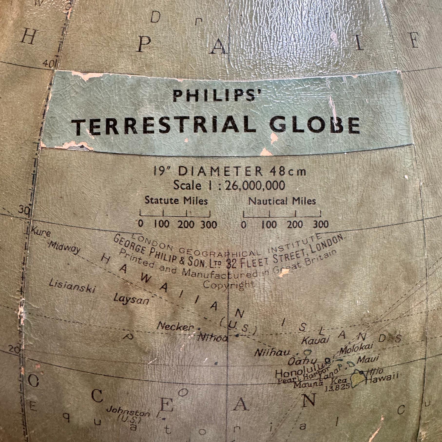 A superb decorators' interior design piece, this very large hanging globe made by the Philips' company in the 1950's hangs from a brass chain, the metal globe with applied paper map to the surface, some areas of loss and a few small dents and knocks