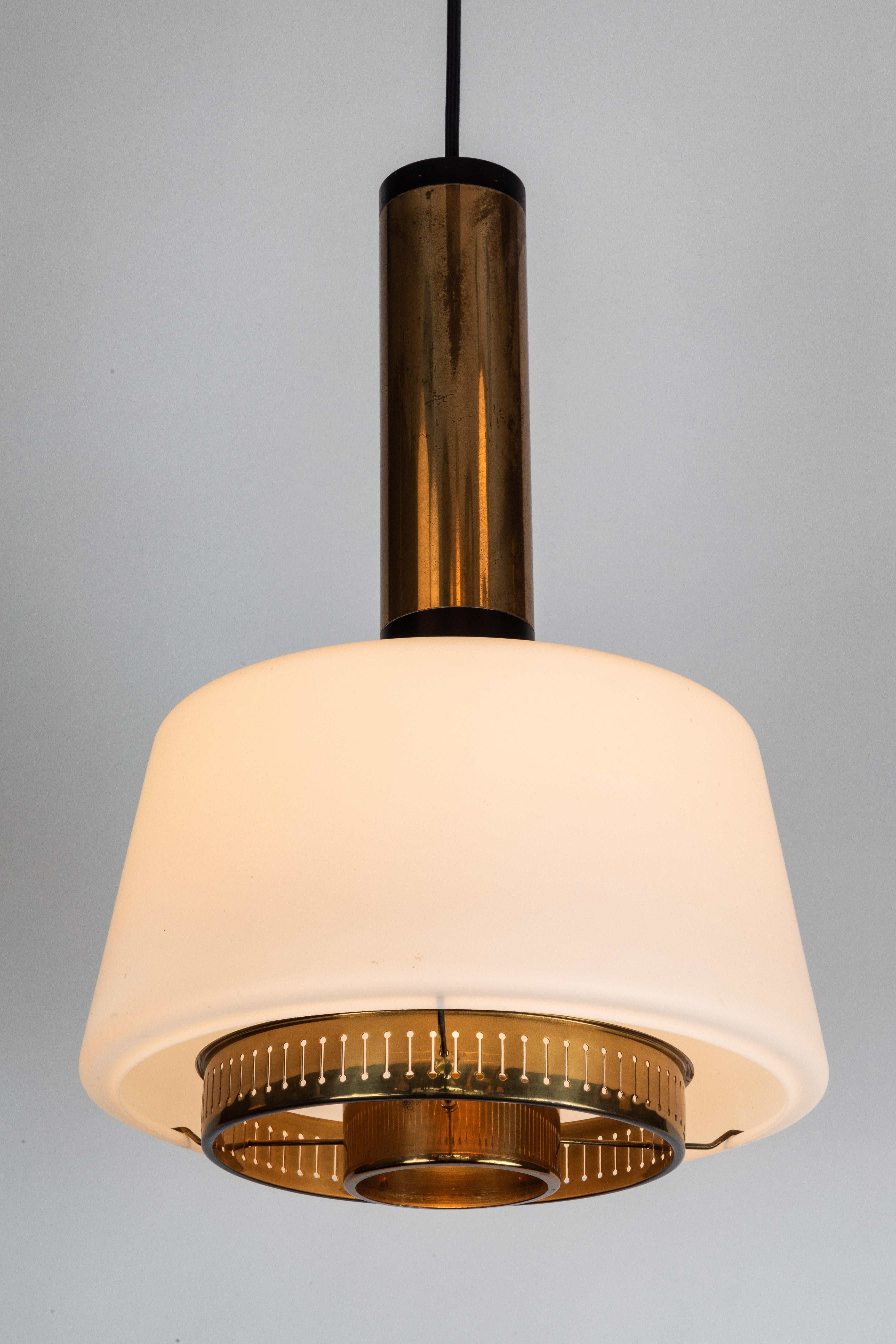 Large 1950s Stilnovo Model #1192 brass and glass pendant. A quintessentially 1950s Italian design executed in matte finish opaline glass and brass with a custom fabricated architectural ceiling canopy for mounting over a standard American J-box. A