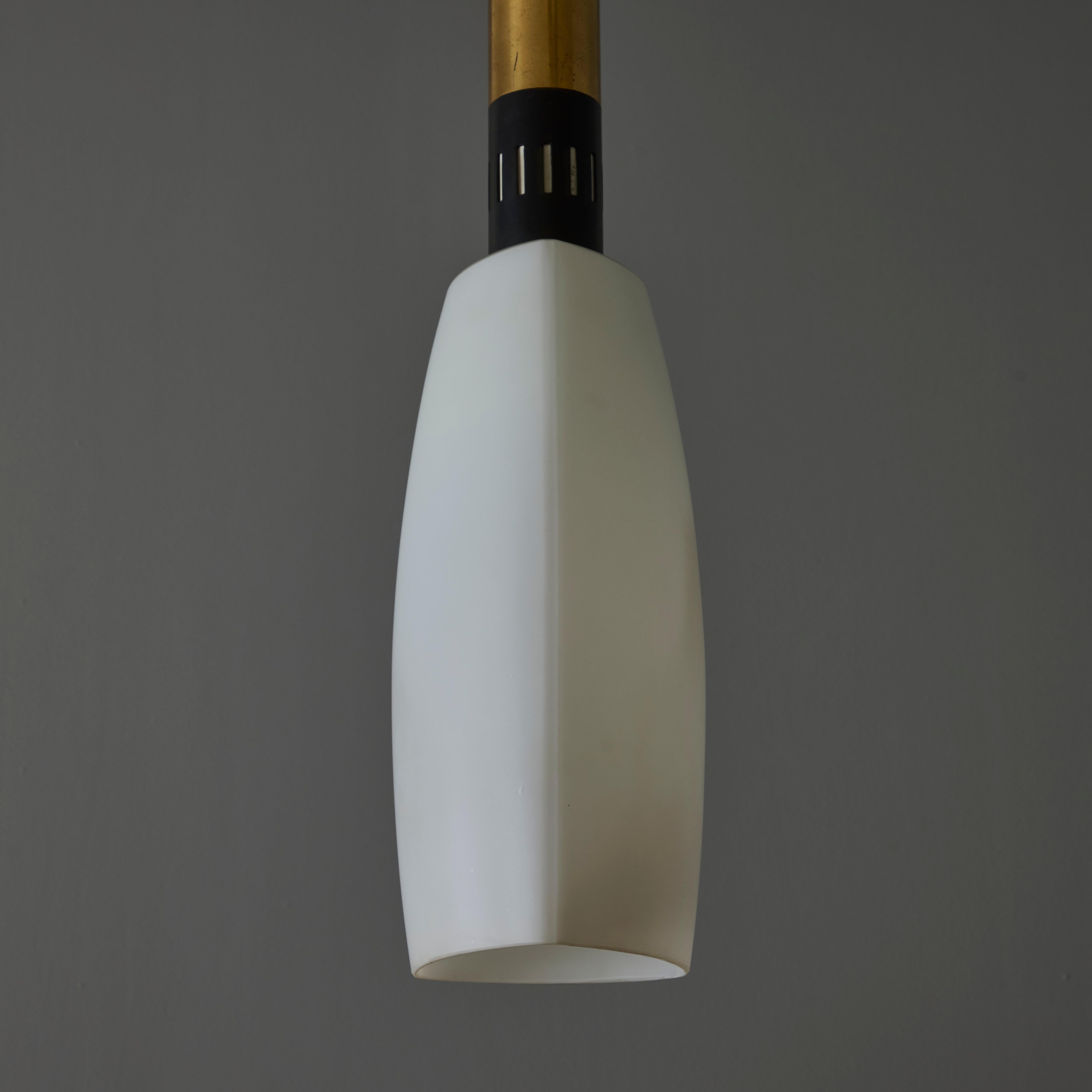 Large 1950s Stilnovo Opaline Glass and Brass Pendant Lamp.

Executed in brass with a sculptural three sided opaline glass. An incomparably clean and refined design characteristic of midcentury Italian lighting at its highest level. Unmarked.

Price
