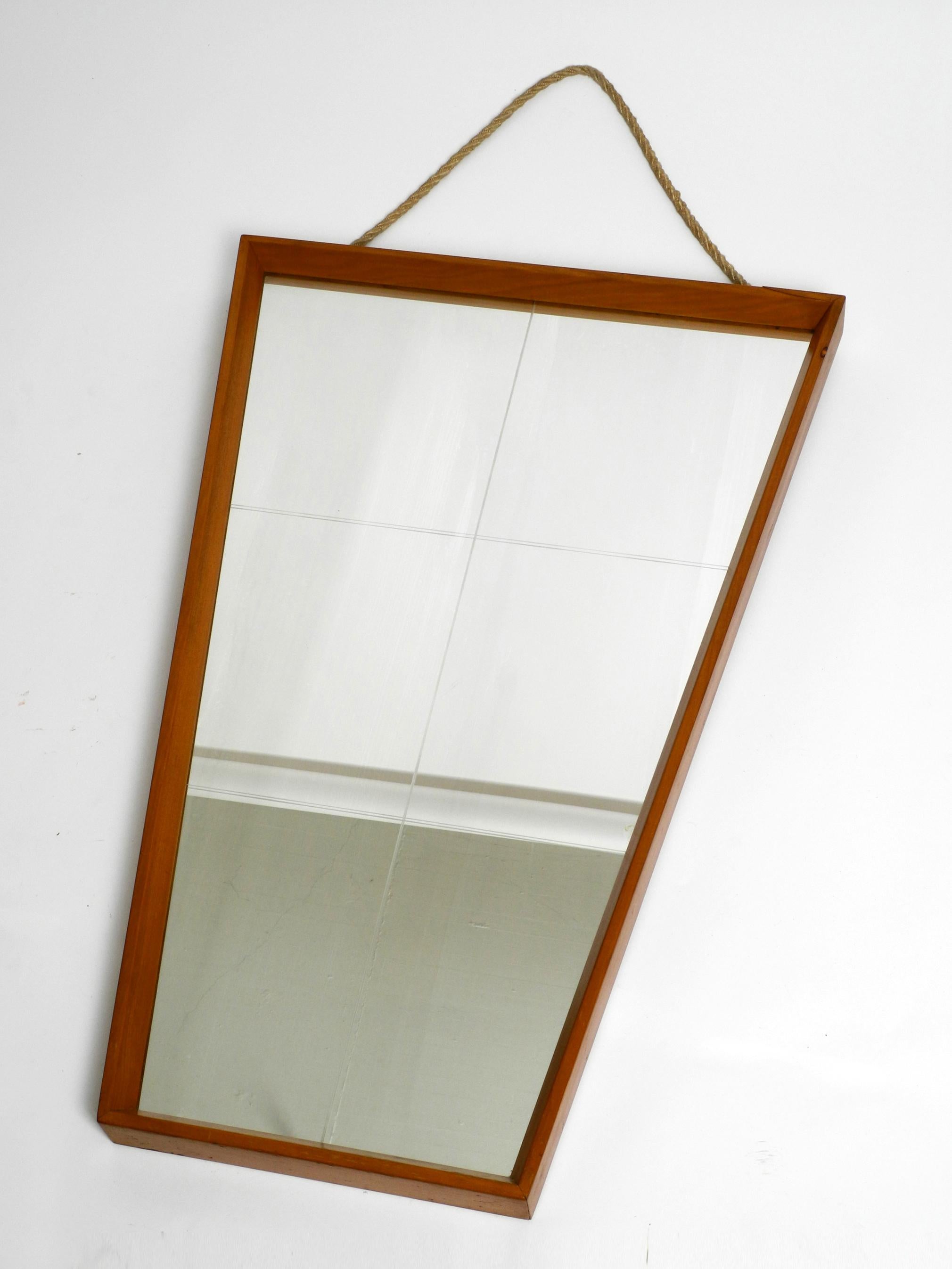 Mid-Century Modern Large 1950s wall mirror in trapezoidal shape with a solid cherry wood frame For Sale