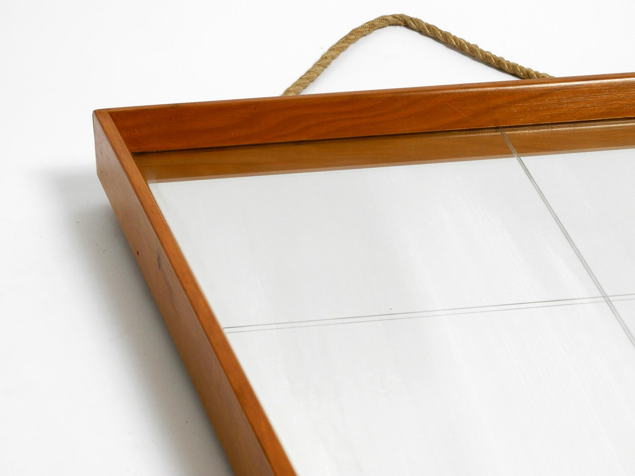 Mid-20th Century Large 1950s wall mirror in trapezoidal shape with a solid cherry wood frame For Sale