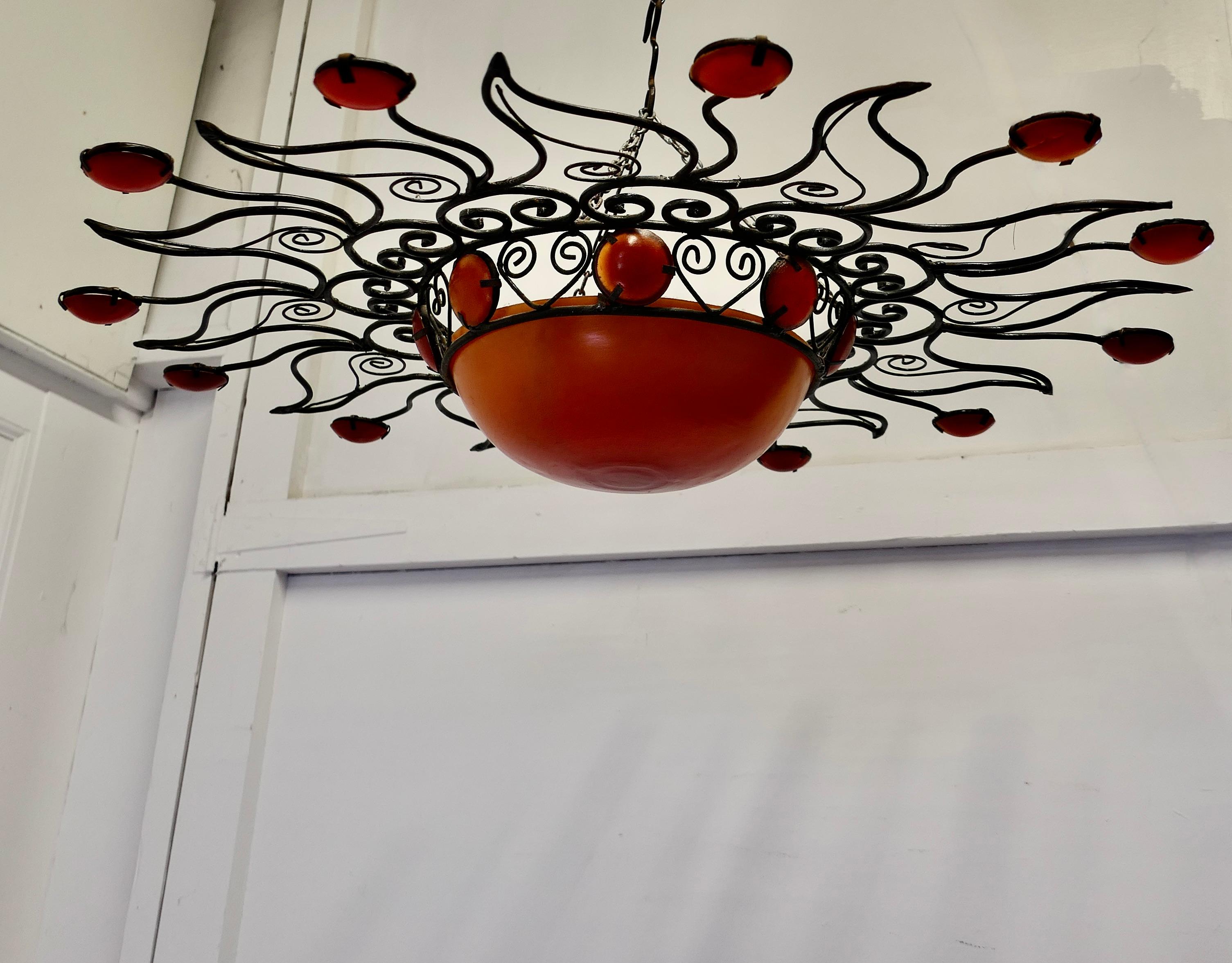 Large 1960s Moroccan Wrought Iron Sun Lamp Shade

A Super piece of Retro Decoration, the wrought Iron shade can be used with a wall light or alternatively this one has been fitted with hanging chains so it can be hung over a ceiling rose
This is a